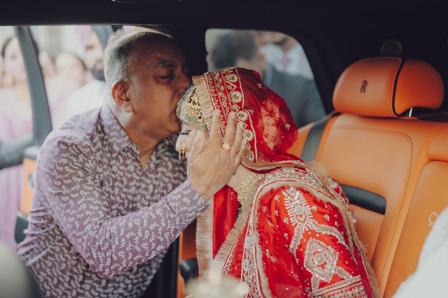 Candid moments captured inside vehicle during traditional Indian wedding celebrations.