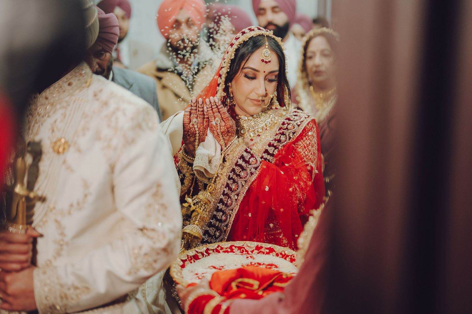 Intimate wedding ceremony moments captured in warm lighting and traditional attire.