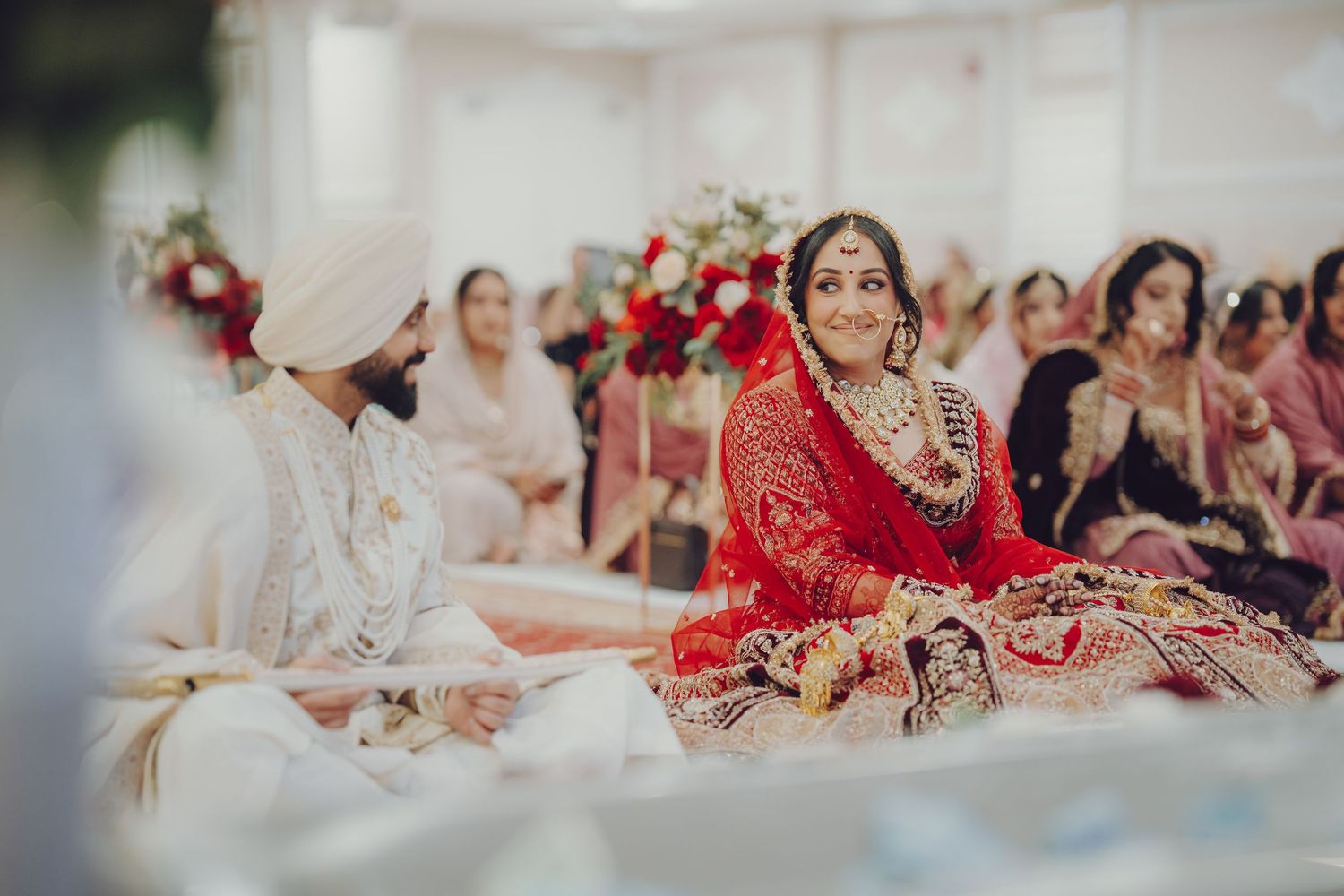 Wedding reception hall filled with guests during an Indian celebration.