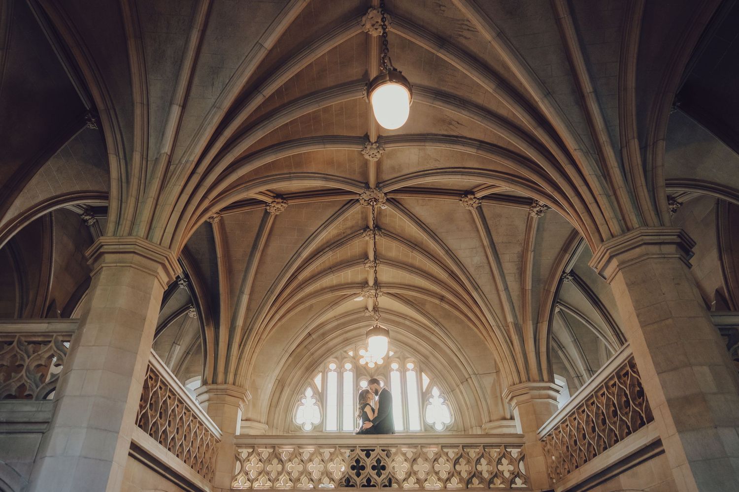 Ornate vaulted cathedral ceiling with gothic architectural details and chandeliers.