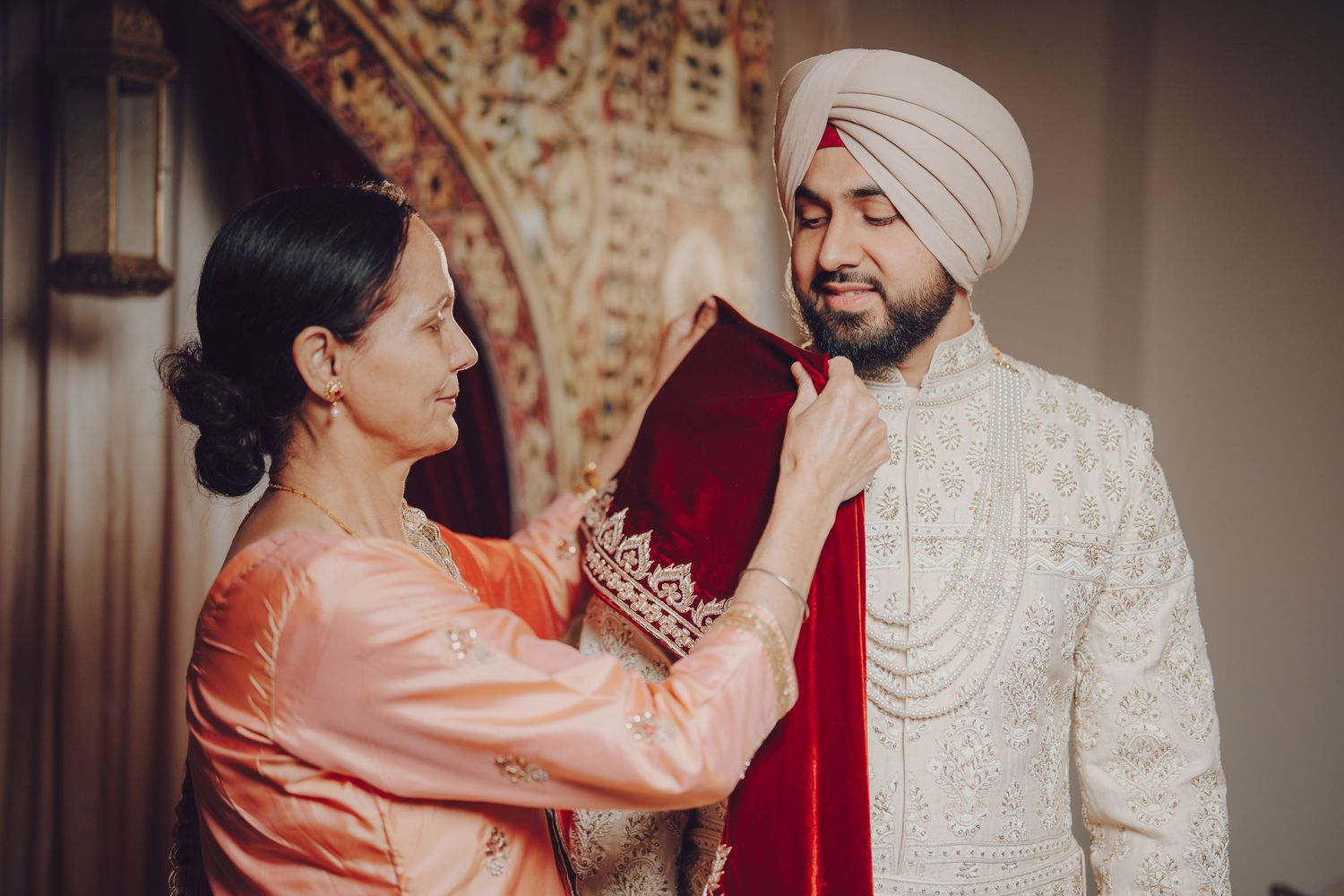 Traditional Sikh wedding ceremony moment with participants in cultural attire.