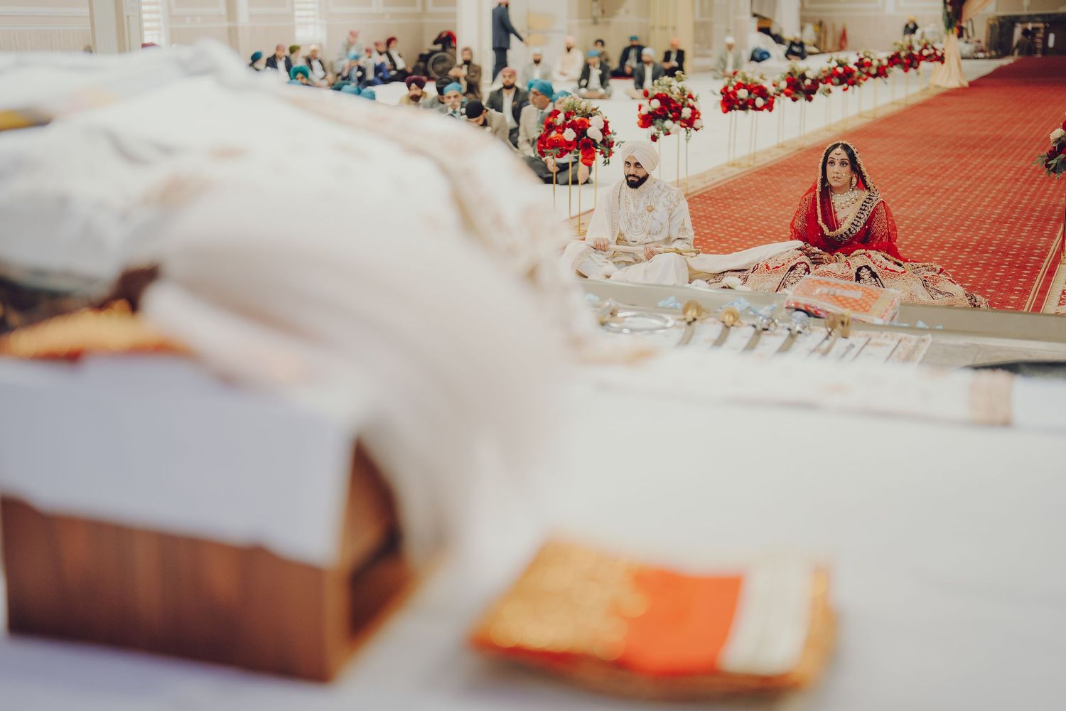 Wedding ceremony setup with decorative elements and red carpet in foreground.