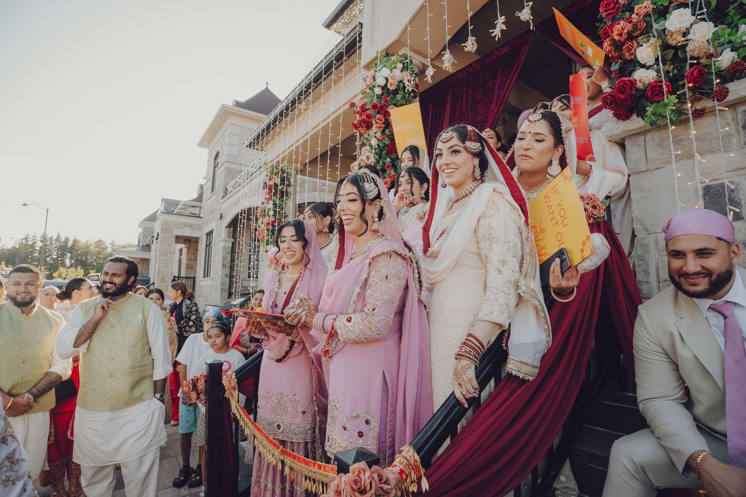 Wedding party and guests celebrating in colorful traditional attire during outdoor procession.