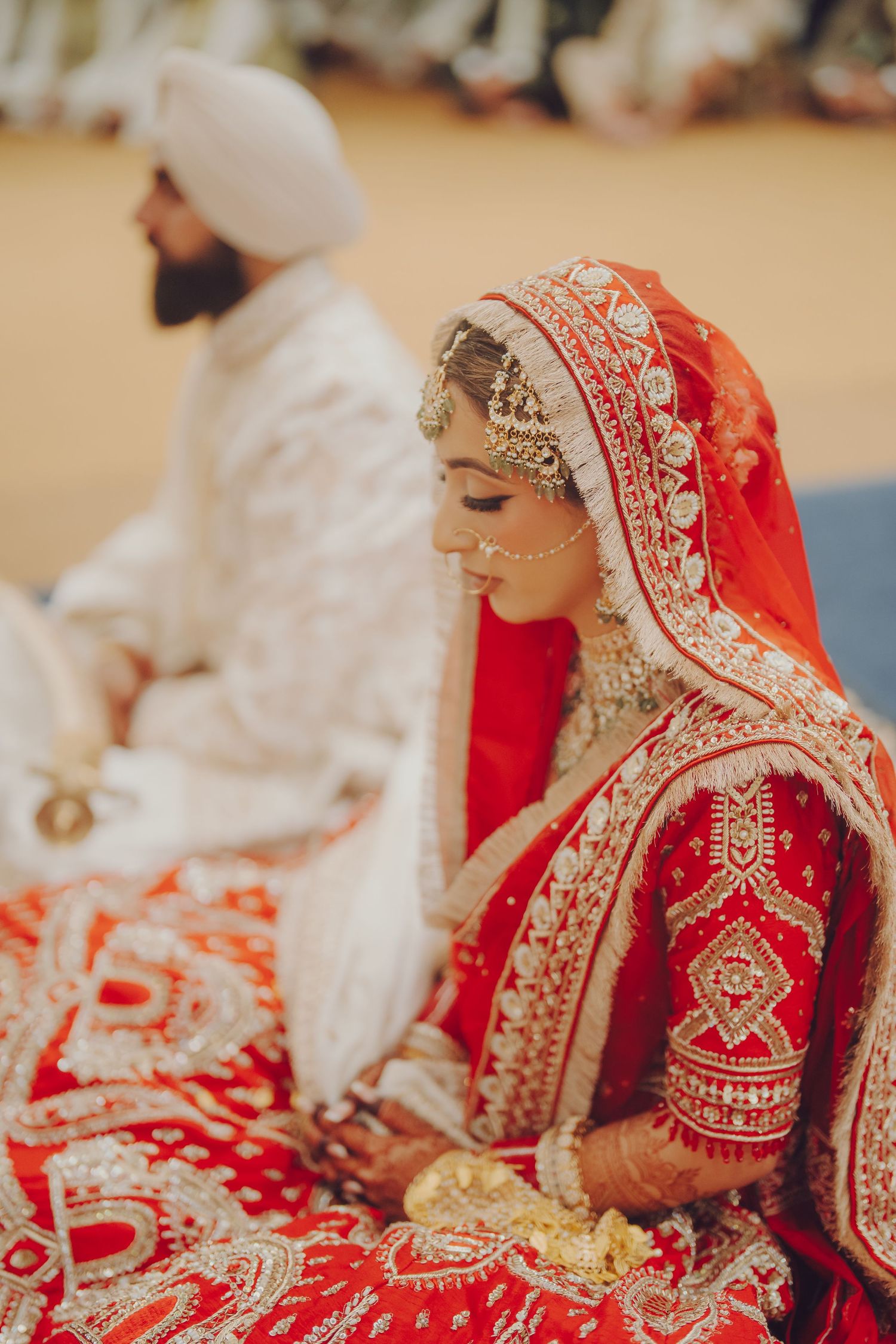 A traditional Sikh wedding ceremony showing the couple during a religious ritual.