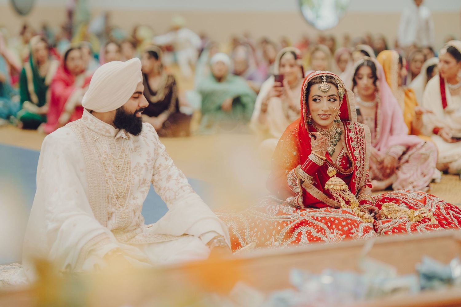 Wedding ceremony panorama showing guests seated in a decorated indoor venue.
