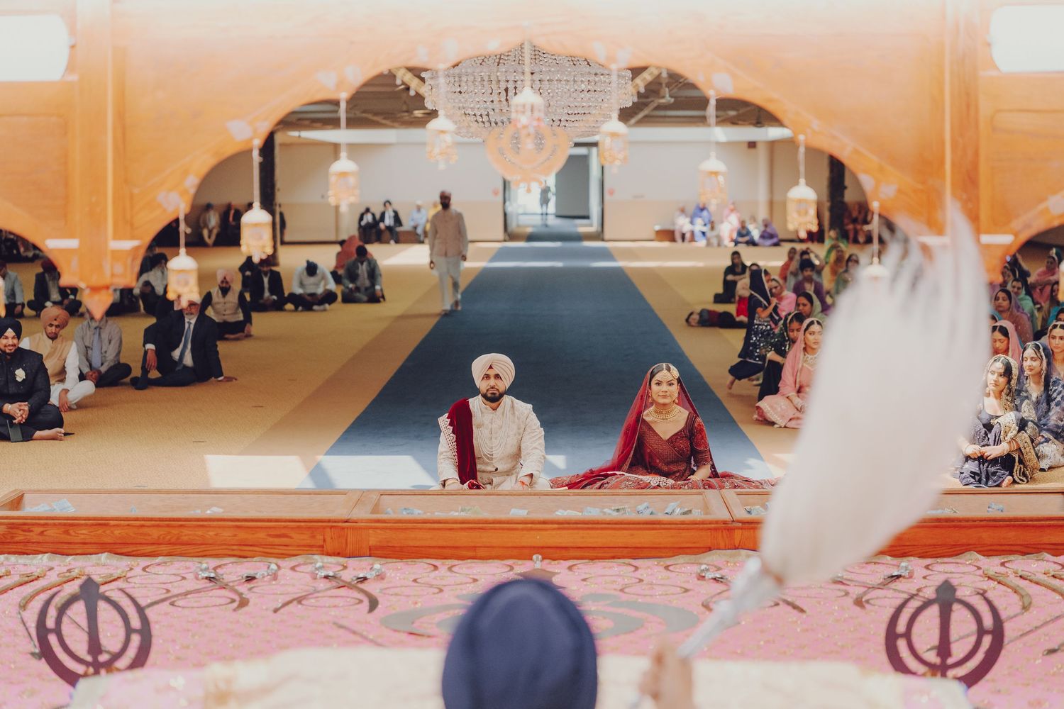 Panoramic view of a traditional wedding ceremony space with pink and white decorative elements.