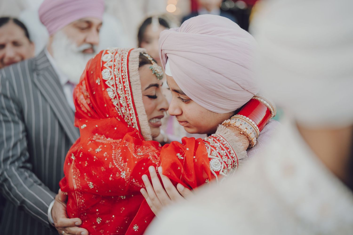 Wedding ceremony moments captured in soft, romantic lighting with traditional attire.