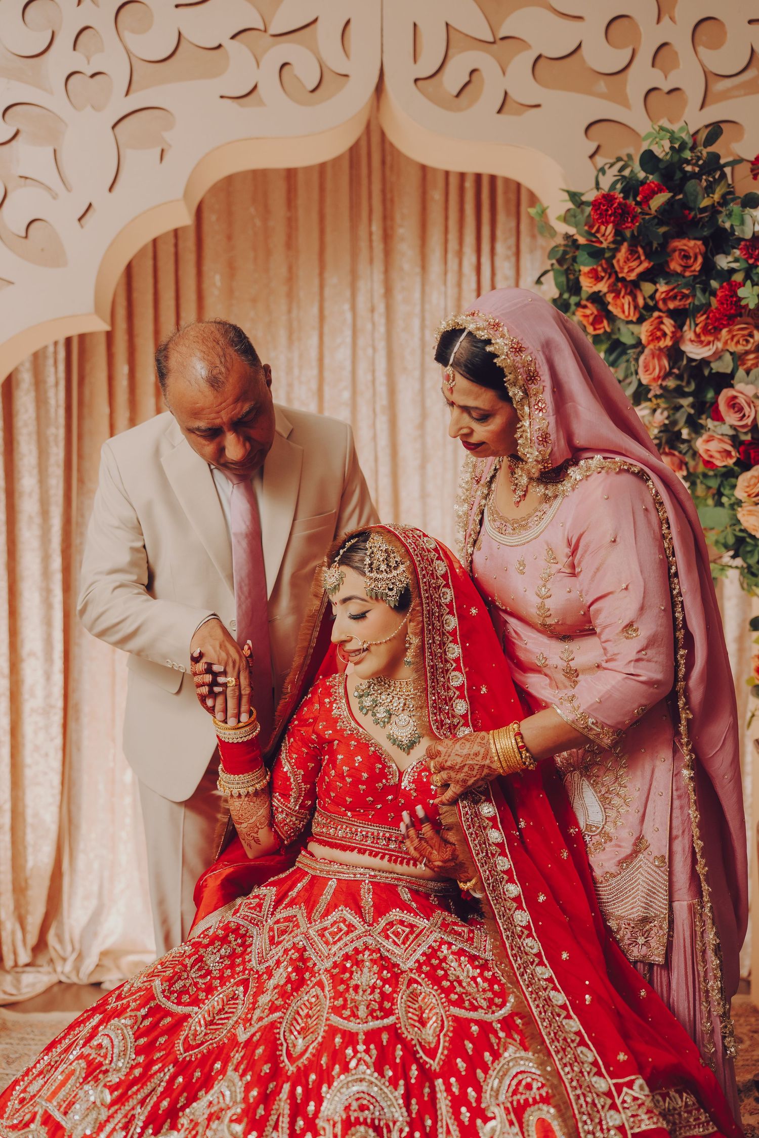 Traditional Indian wedding ceremony showing detailed red lehenga and cultural rituals.