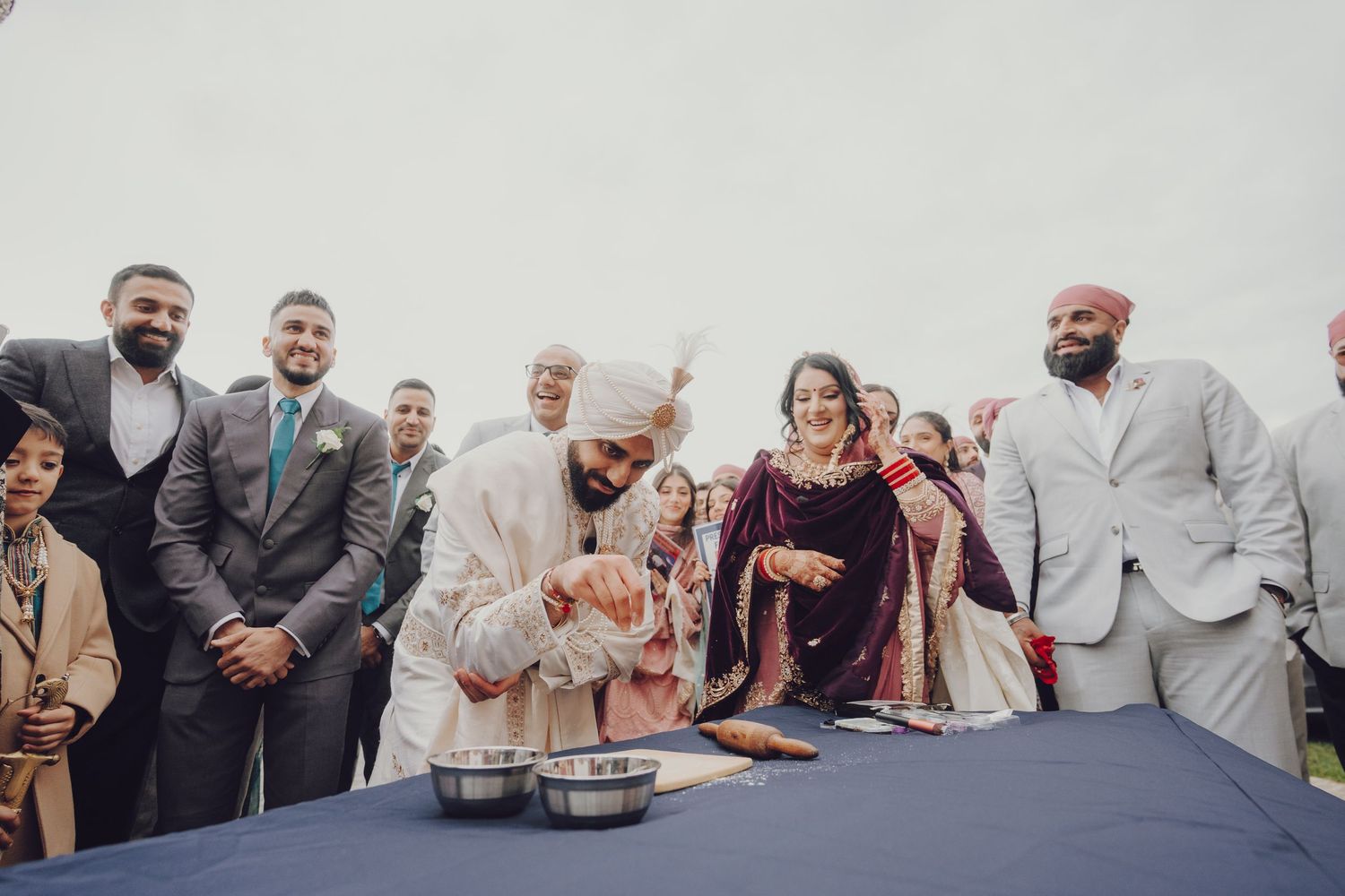 Wedding guests and family members celebrating during a joyous reception moment.