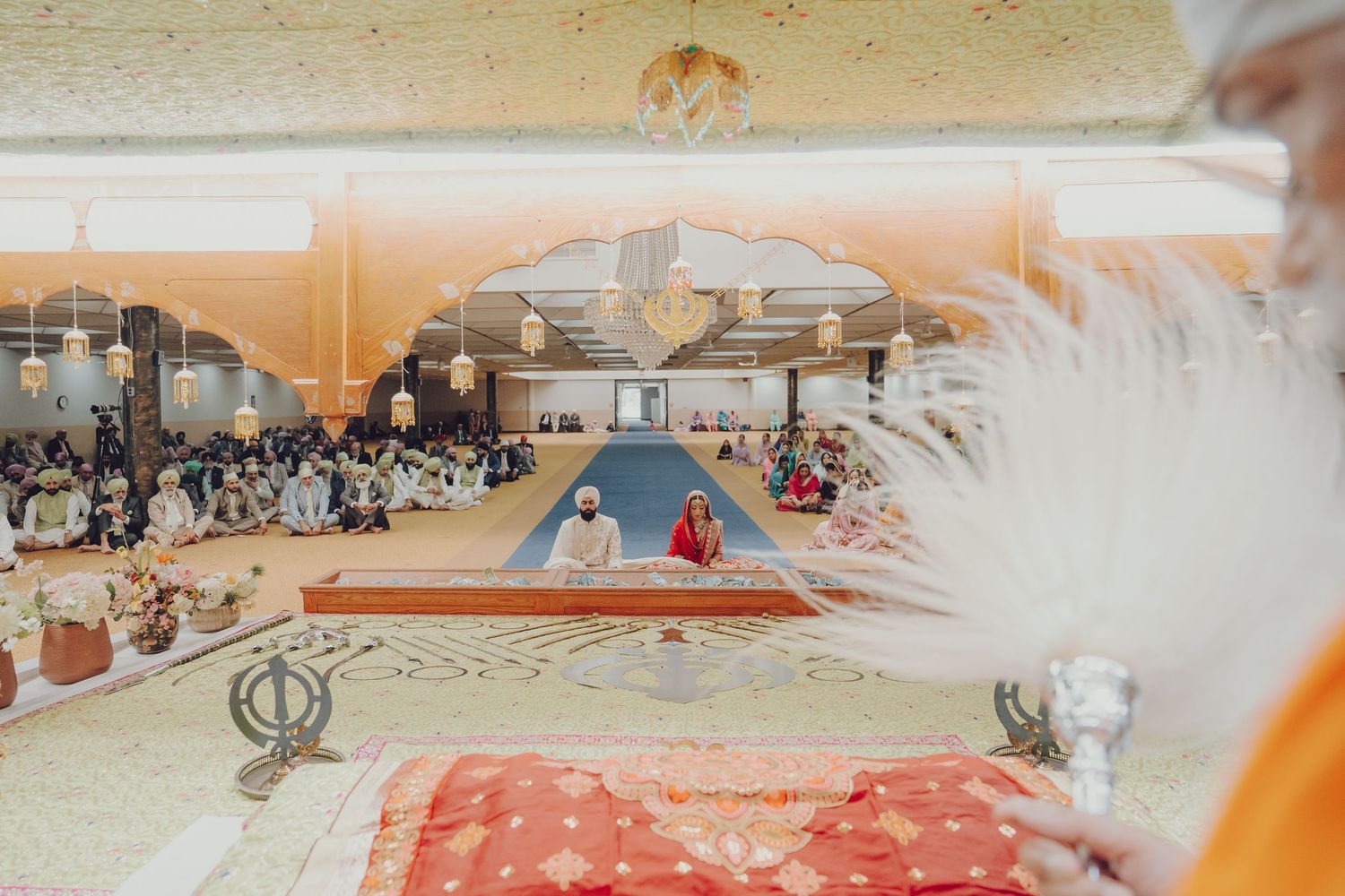 An overhead view of a traditional Sikh wedding ceremony in progress at a Gurdwara.