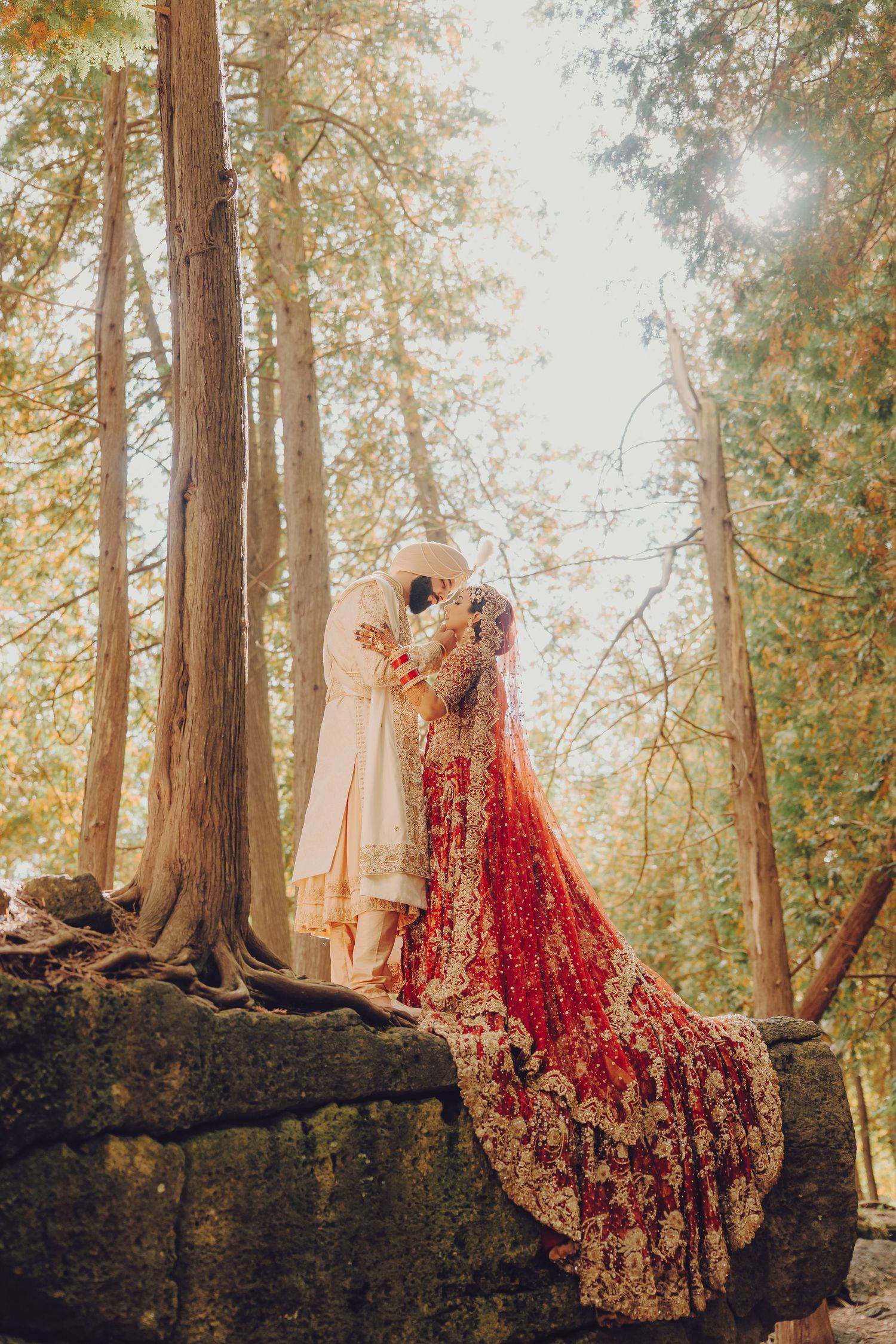 A series of photos showing traditional South Asian bridal attire in red and gold against a misty forest backdrop.