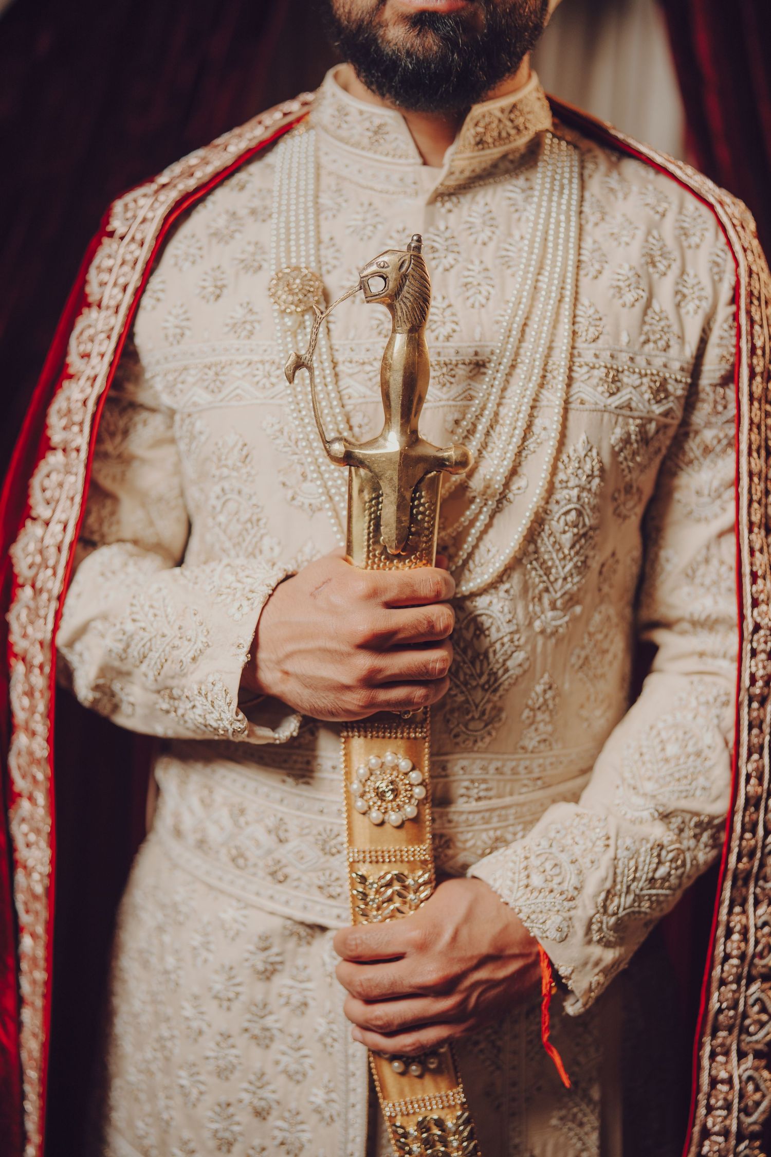 Close-up shots of ornate gold embroidered sherwani with traditional Indian wedding details.