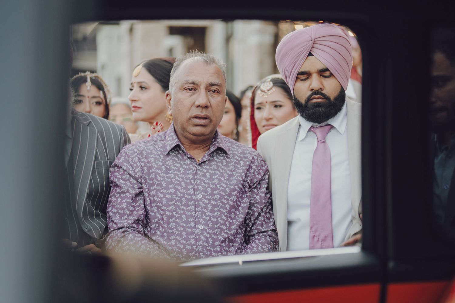 Guests in traditional Punjabi attire attending a Sikh wedding ceremony.