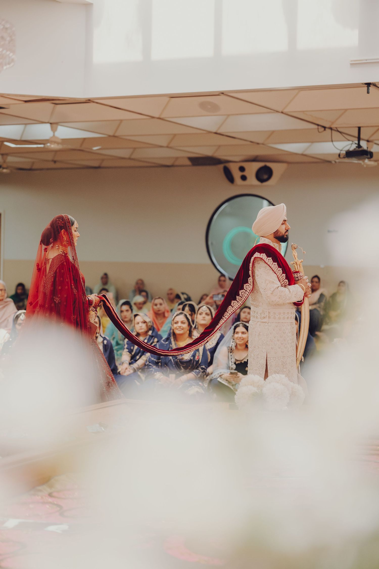 Wedding ceremony in progress with couple in traditional Indian attire.