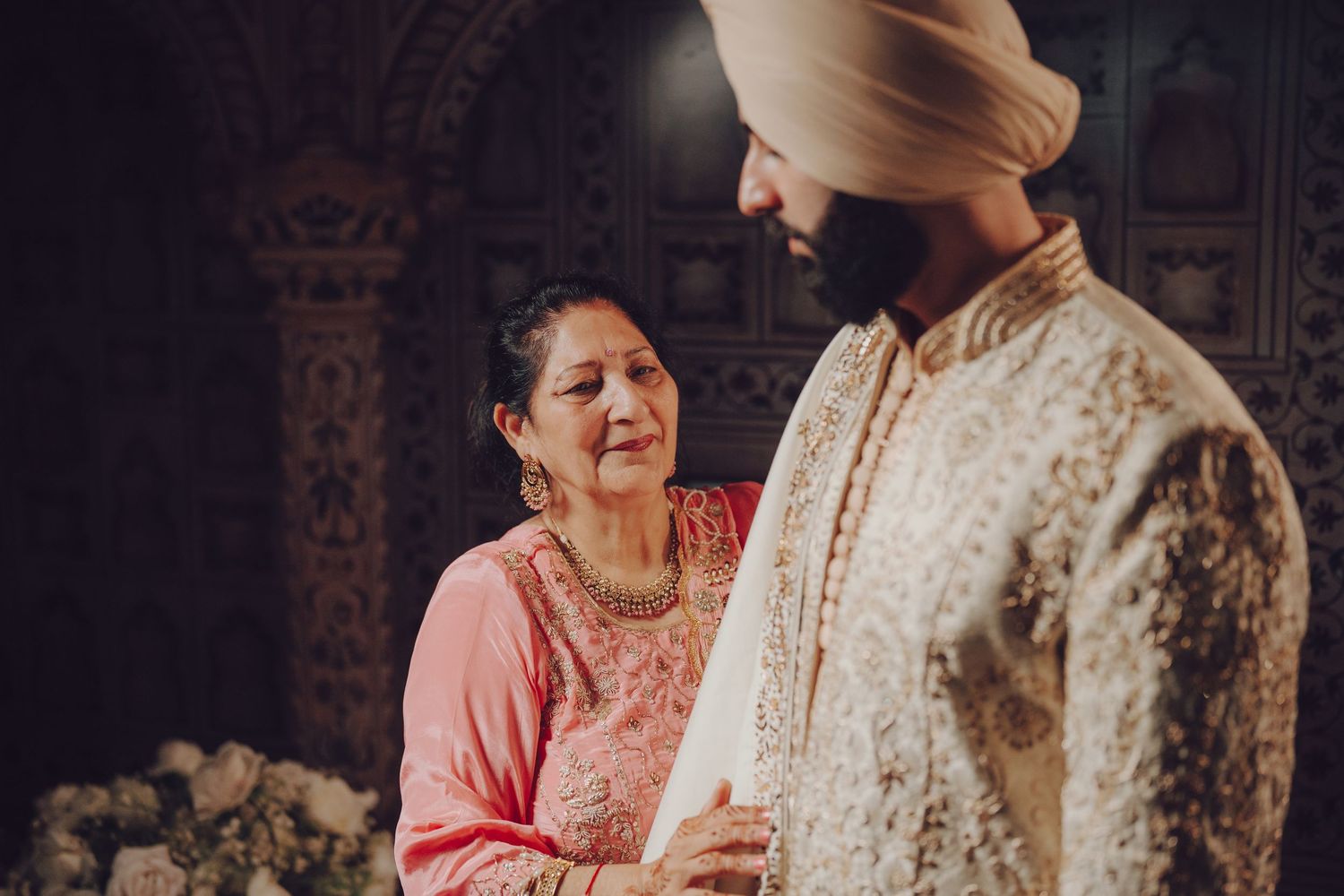 Traditional Indian wedding ceremony preparation in an ornately decorated indoor setting.