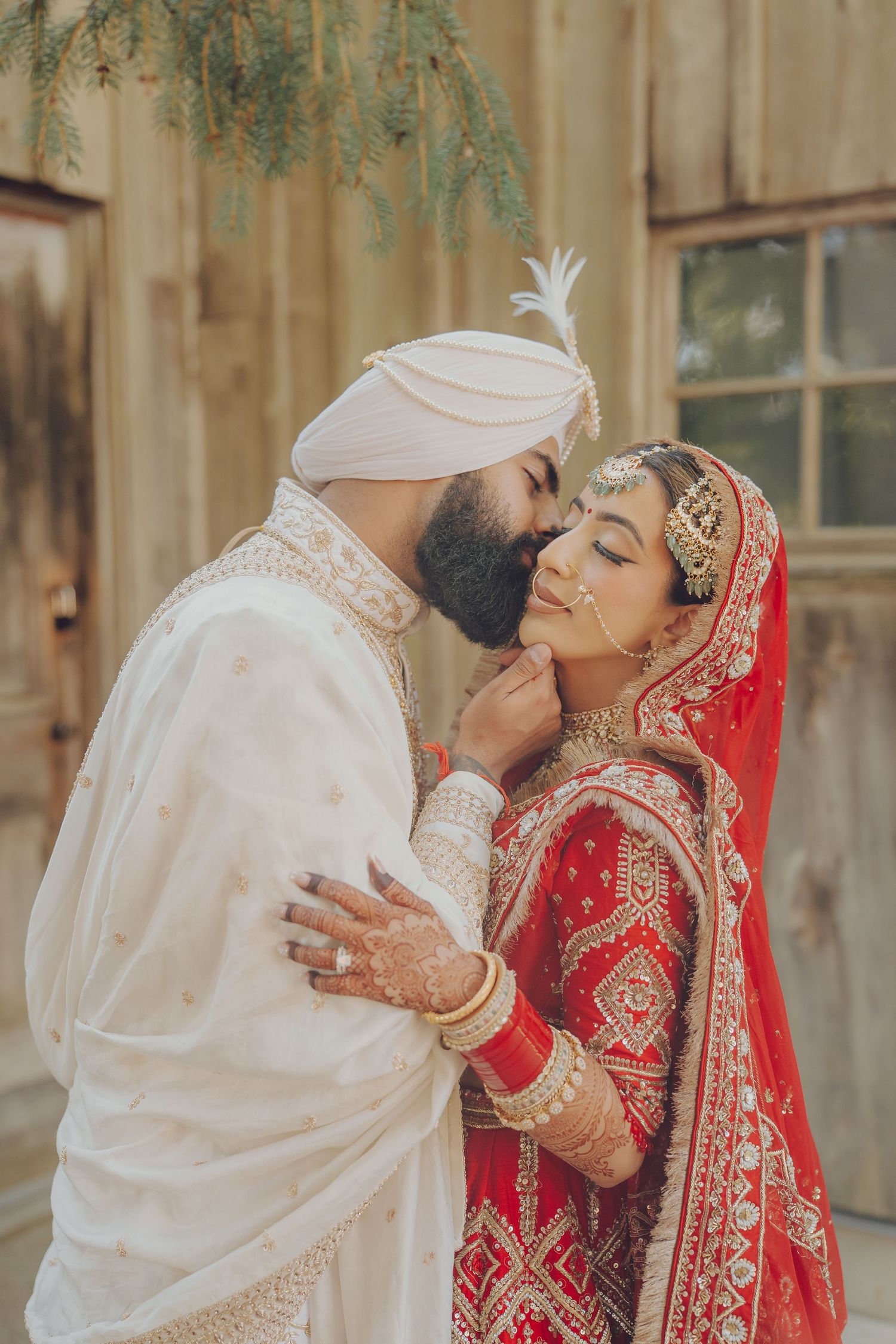 An intimate moment captured between newlyweds in traditional Sikh wedding attire.