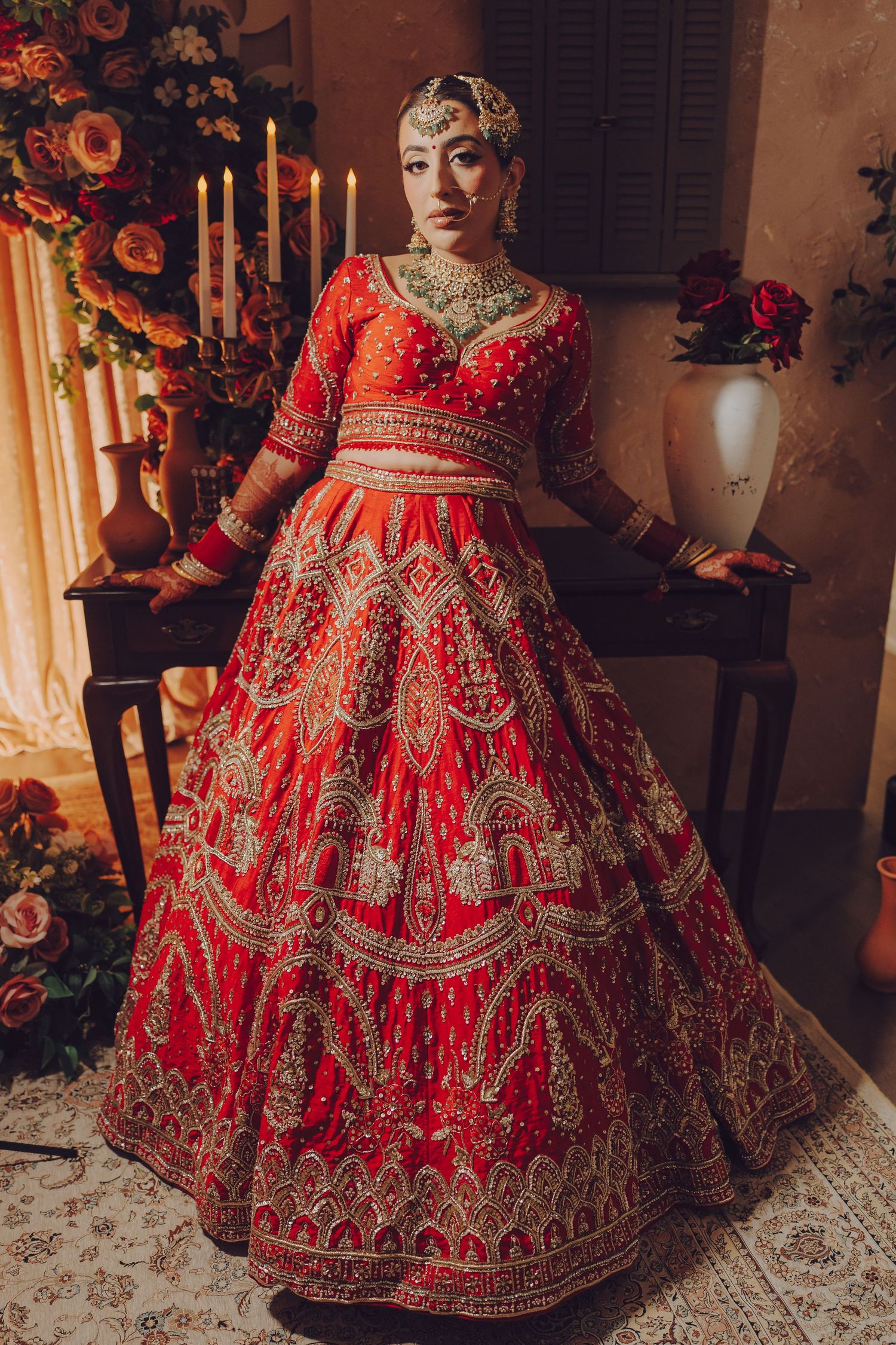 Traditional red bridal lehenga with heavy gold embroidery and detailed zari work displayed in multiple angles.
