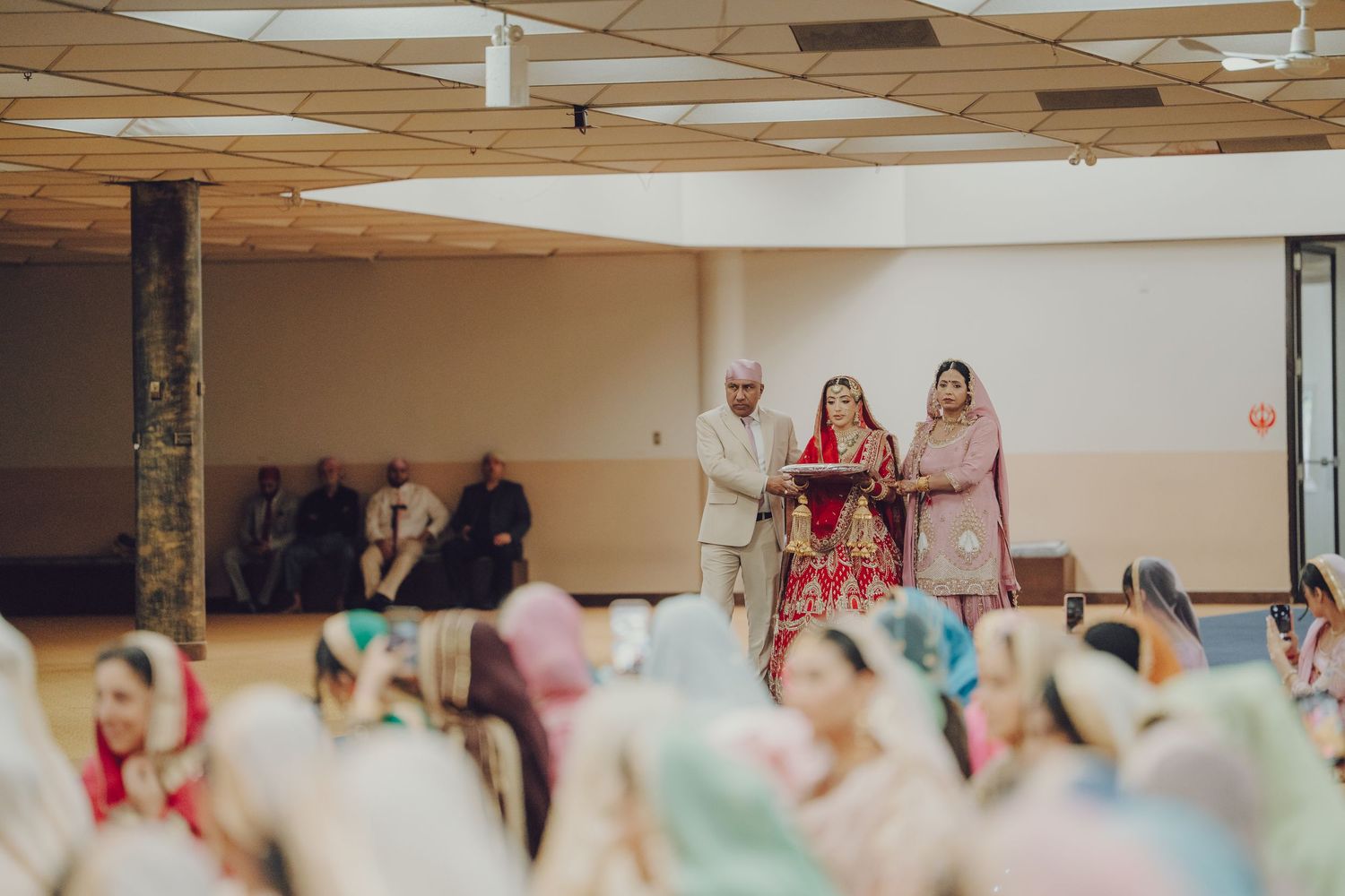Wide panoramic view of a wedding ceremony venue with guests seated in rows.