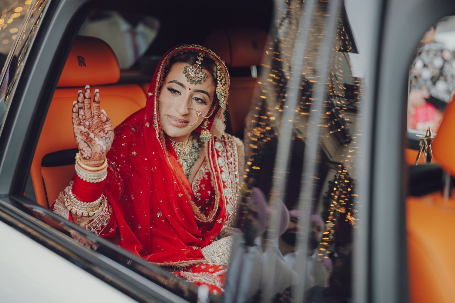 Artistic wedding photography sequence through car window with red bridal attire.