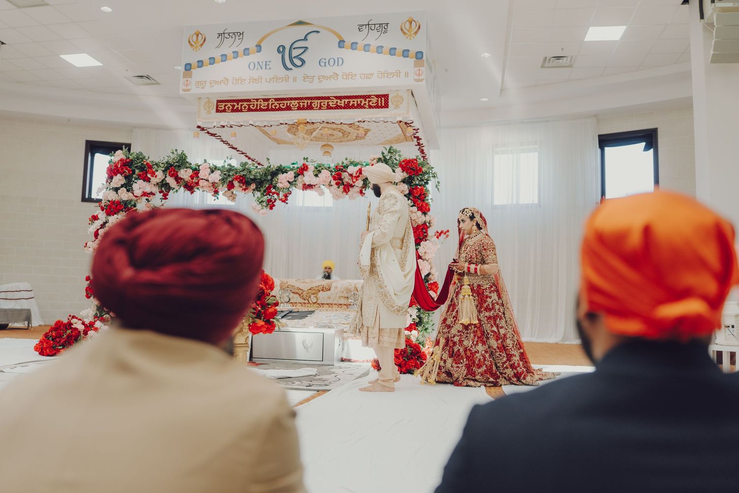 Sikh wedding ceremony space with traditional decorations and symbolic religious elements on display.