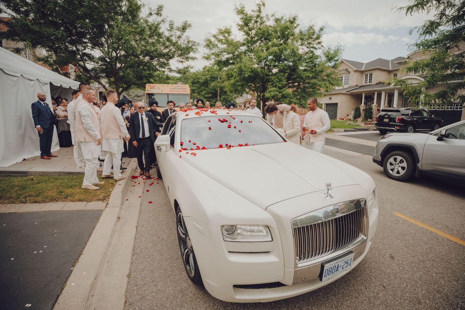 White Rolls-Royce luxury cars lined up for an elegant wedding procession.