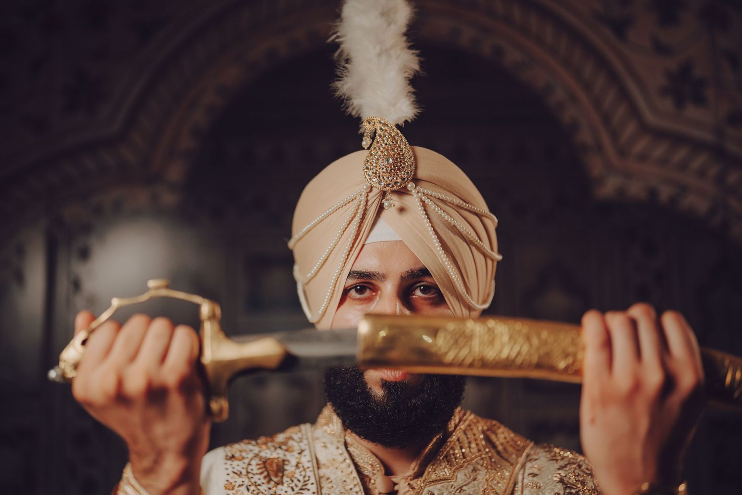 A close-up shot of ceremonial sword being held during a traditional Sikh wedding ritual.