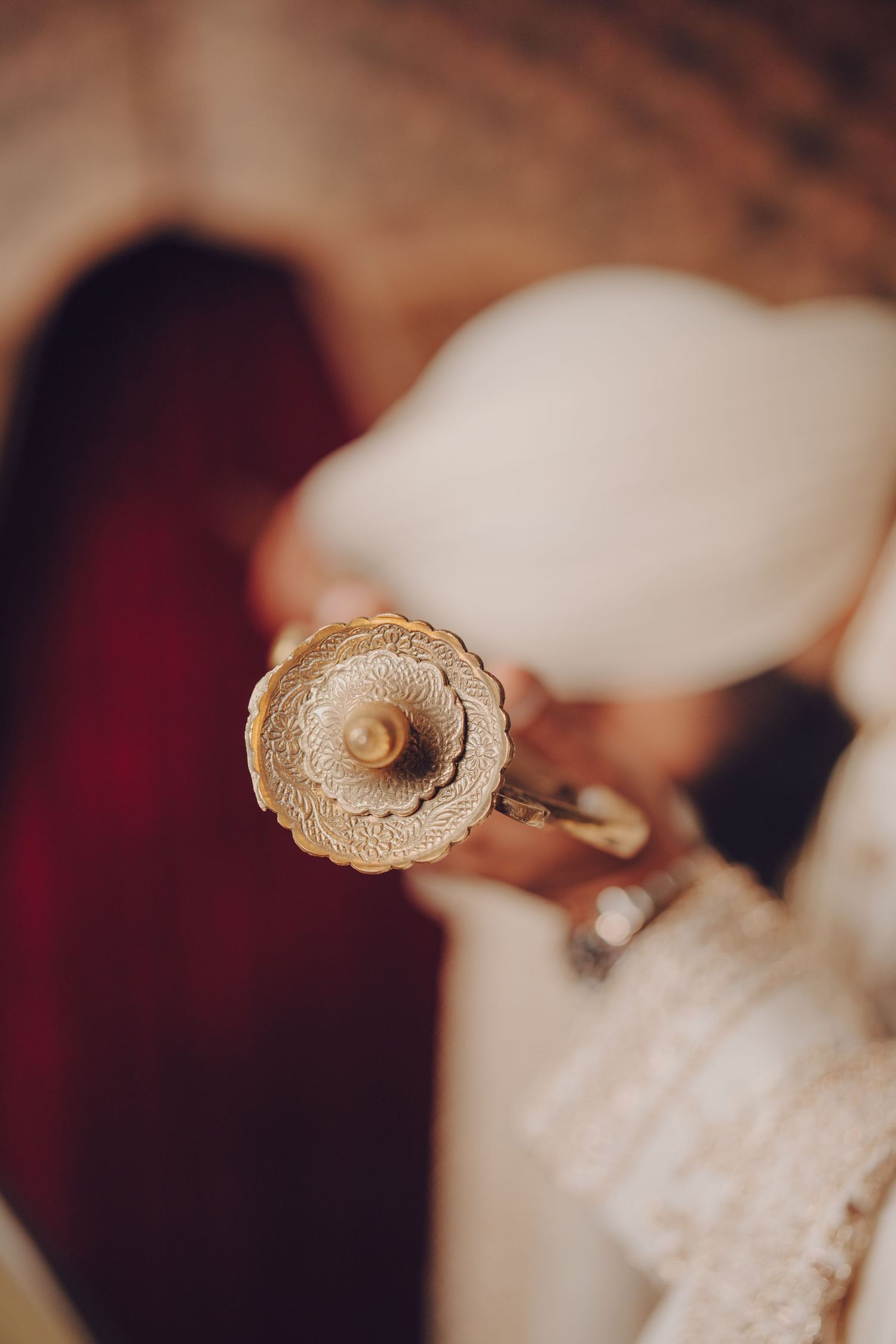 Close-up detail of intricate gold embroidery on traditional Indian wedding attire.