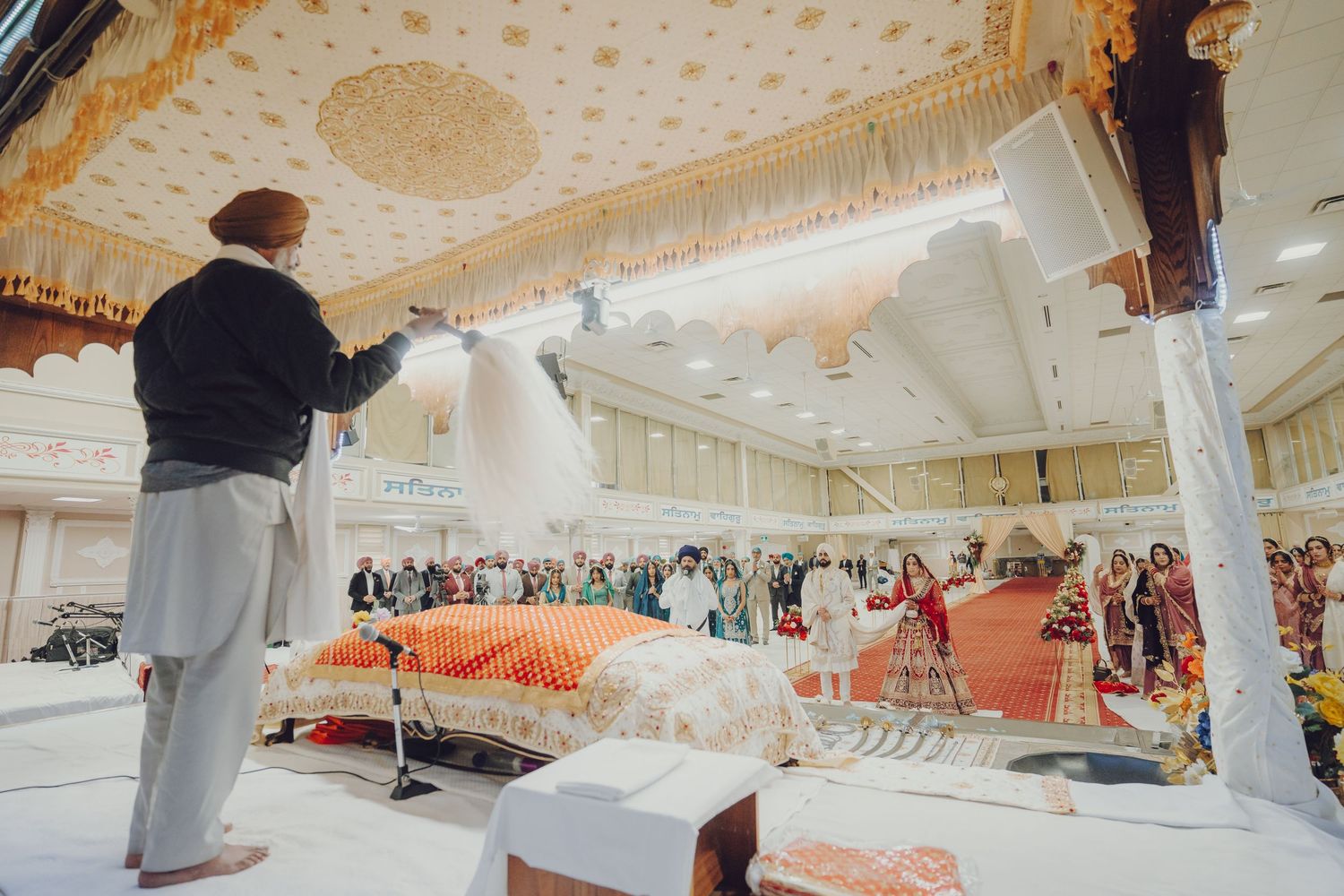 Interior view of a decorated wedding venue ceiling with traditional Indian decor.