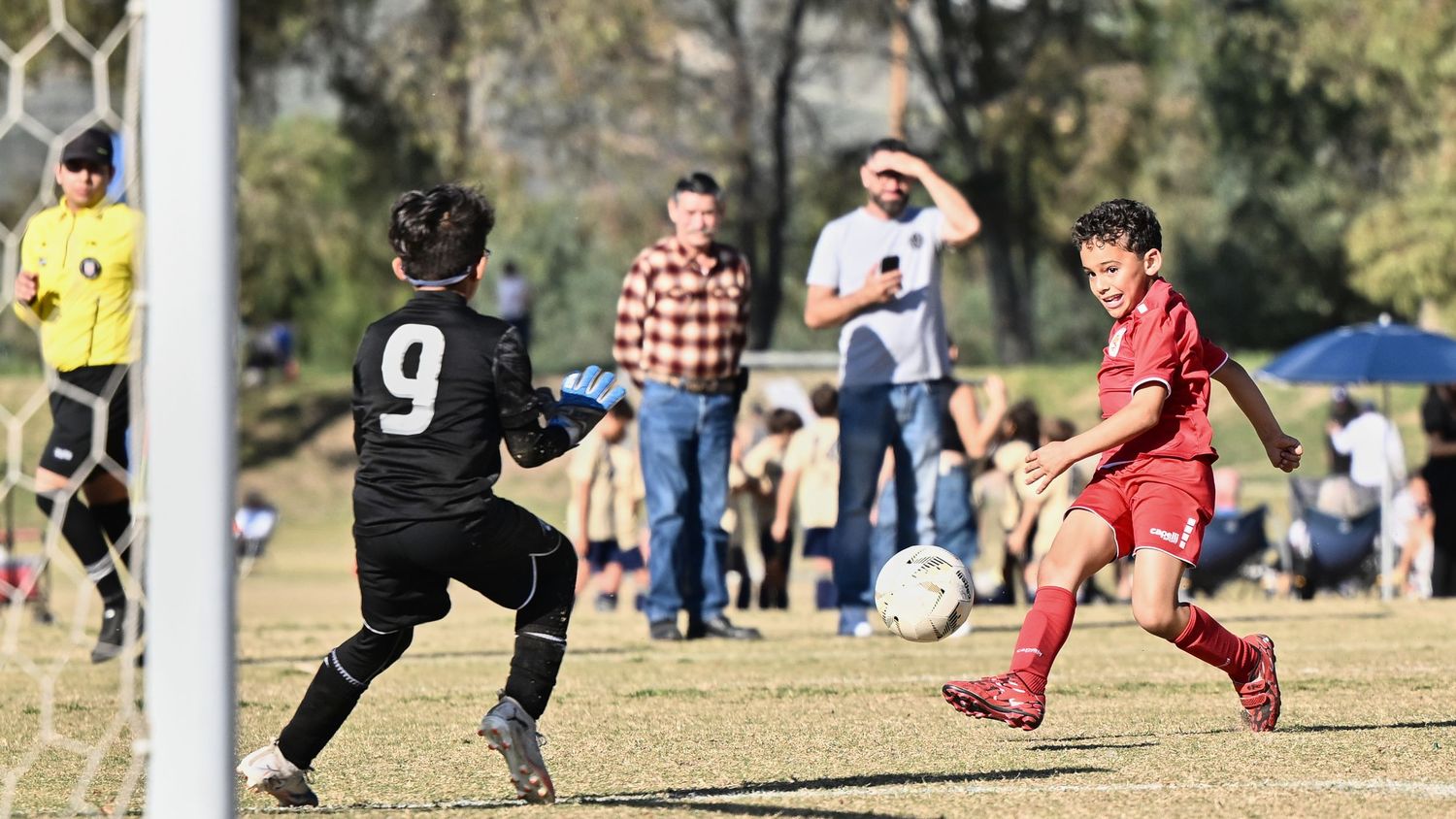 Soccer goal post and field markings during a youth match.