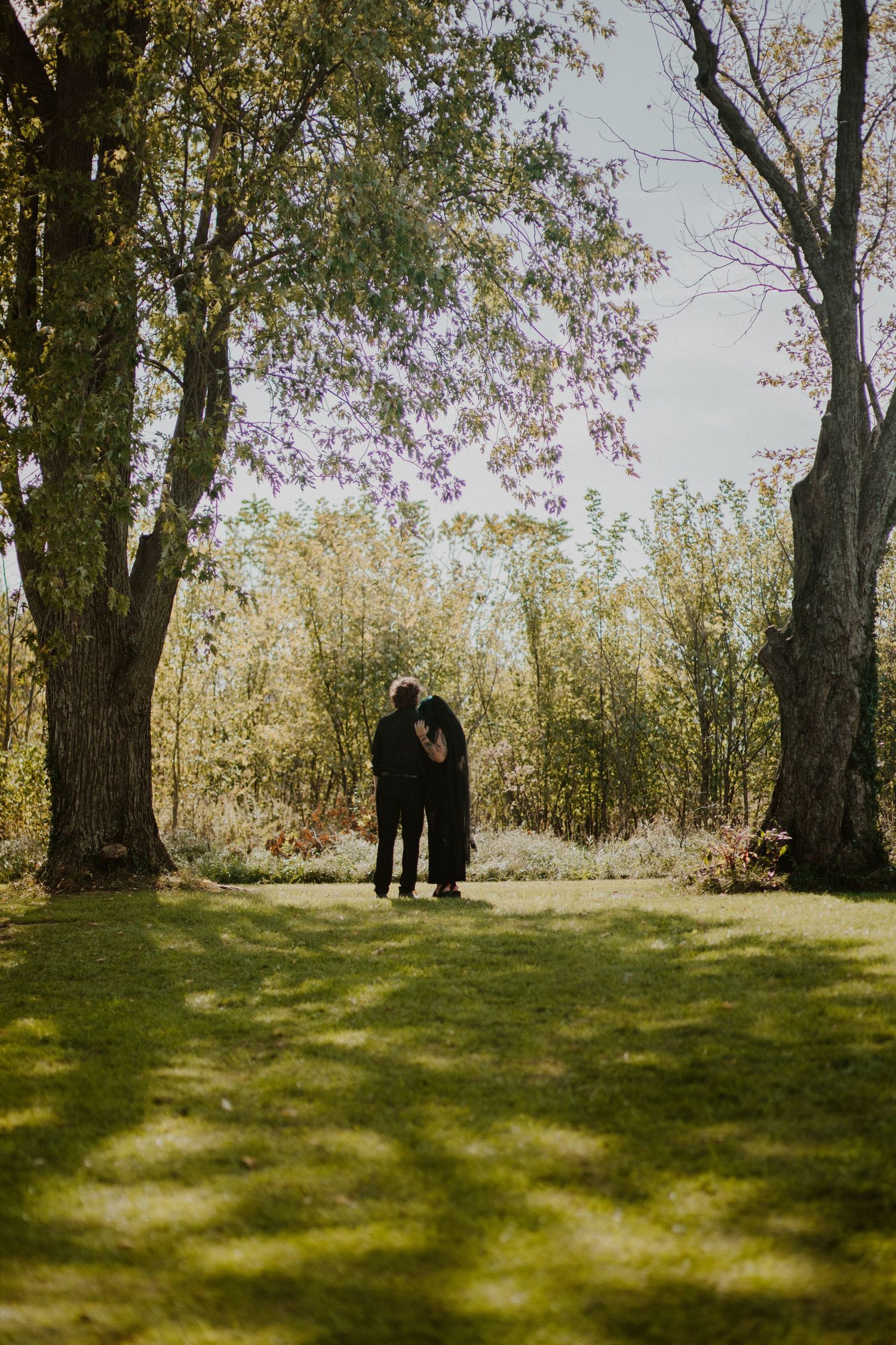 Elopement, Newly married couple embrace between two tall trees, richmond ky photographer