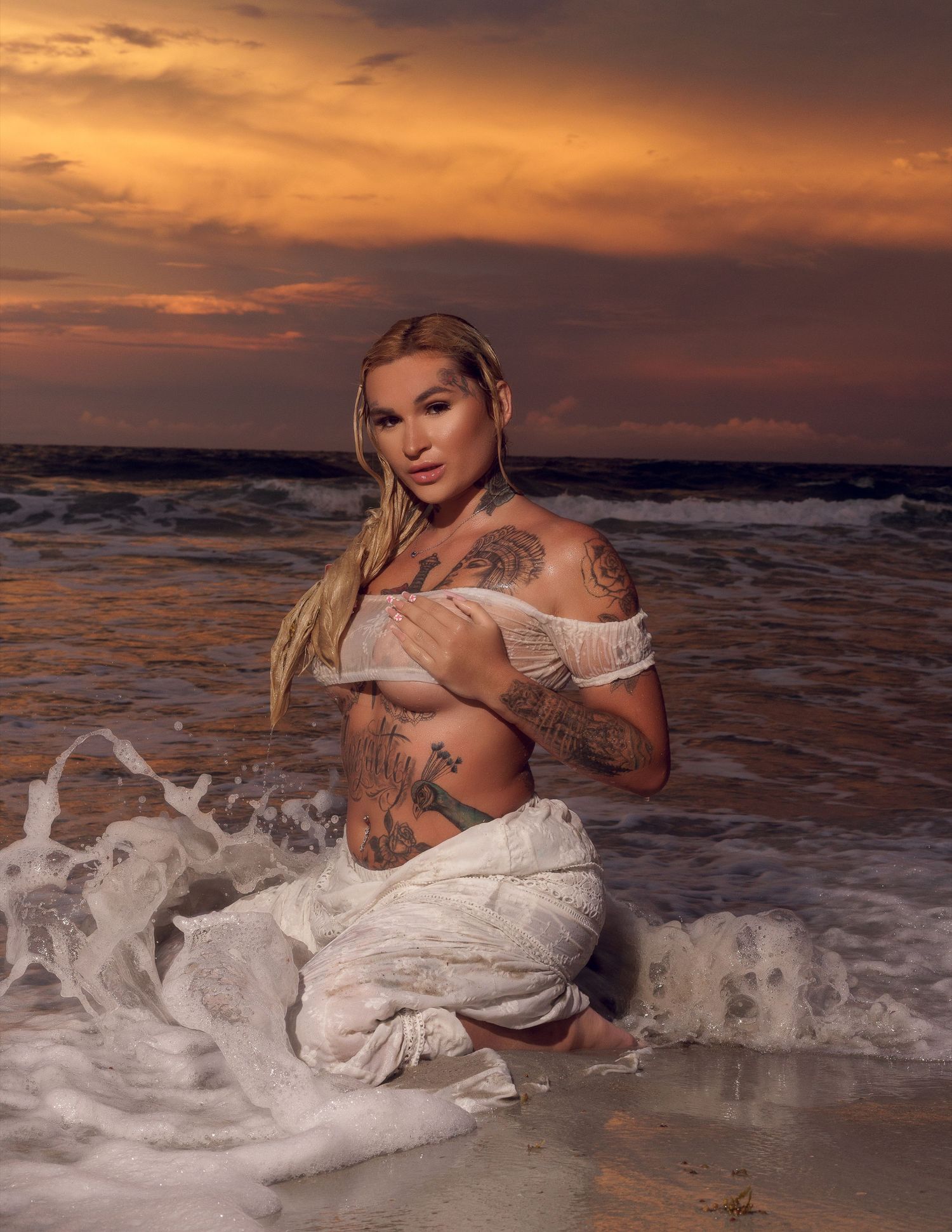 Artistic beach photography at sunset with dramatic orange sky and ocean waves.