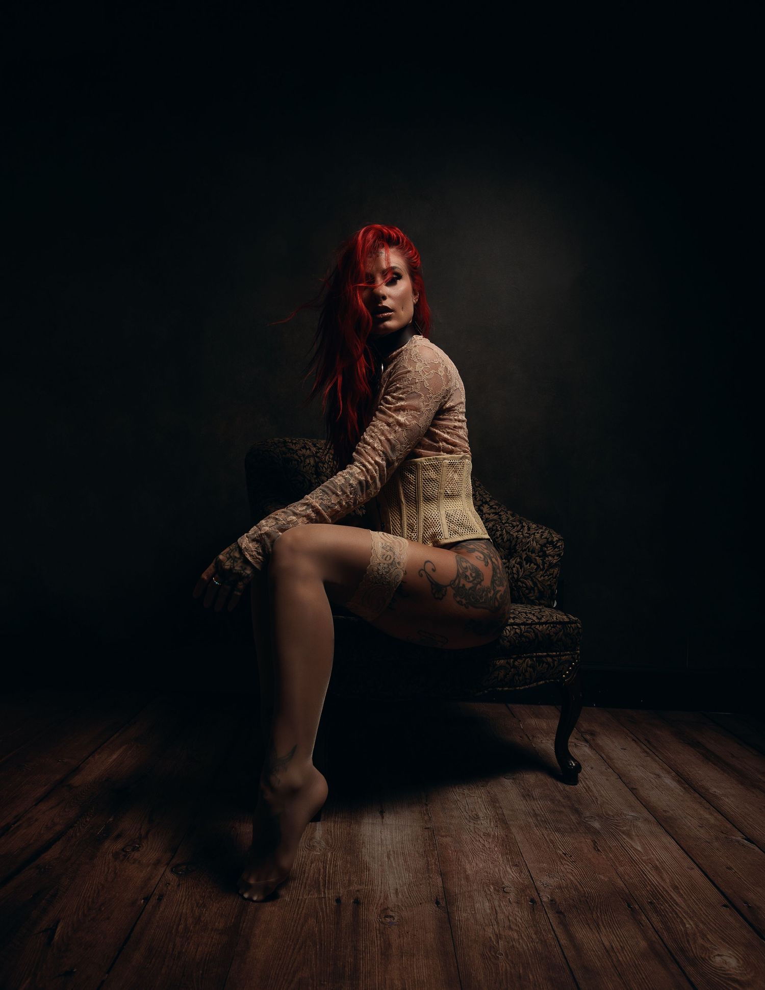 Vintage style portrait with tan corset on antique chair.