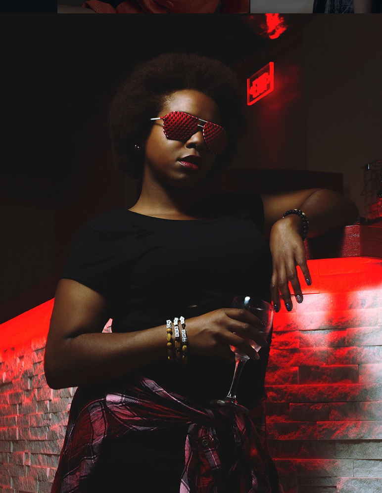 Dramatic nightclub scene with red lighting and brick wall background.