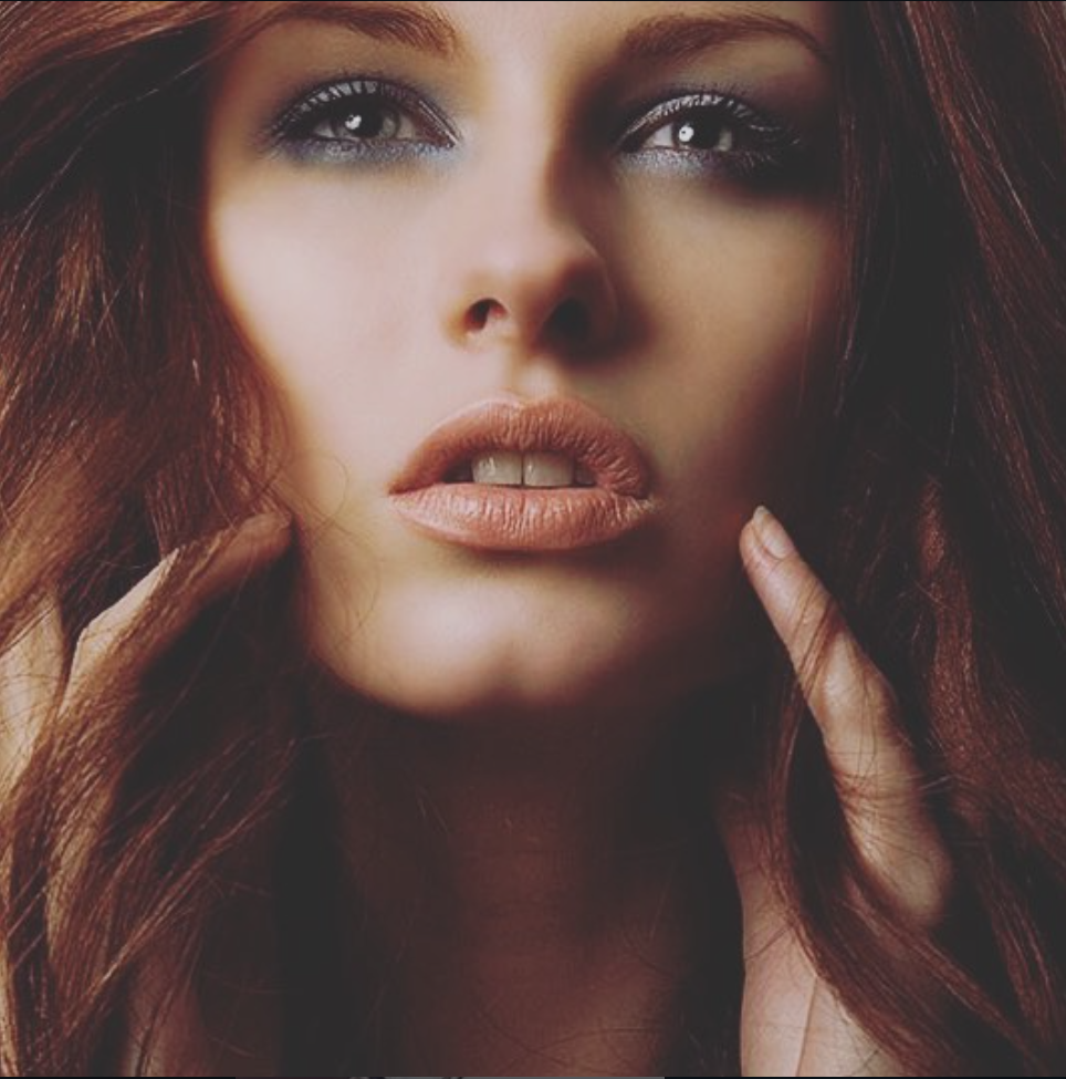 Close-up beauty shots showing dramatic makeup and red hair in warm tones.