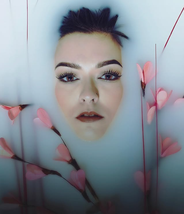 Ethereal close-up photography with soft focus and pink cherry blossom elements.
