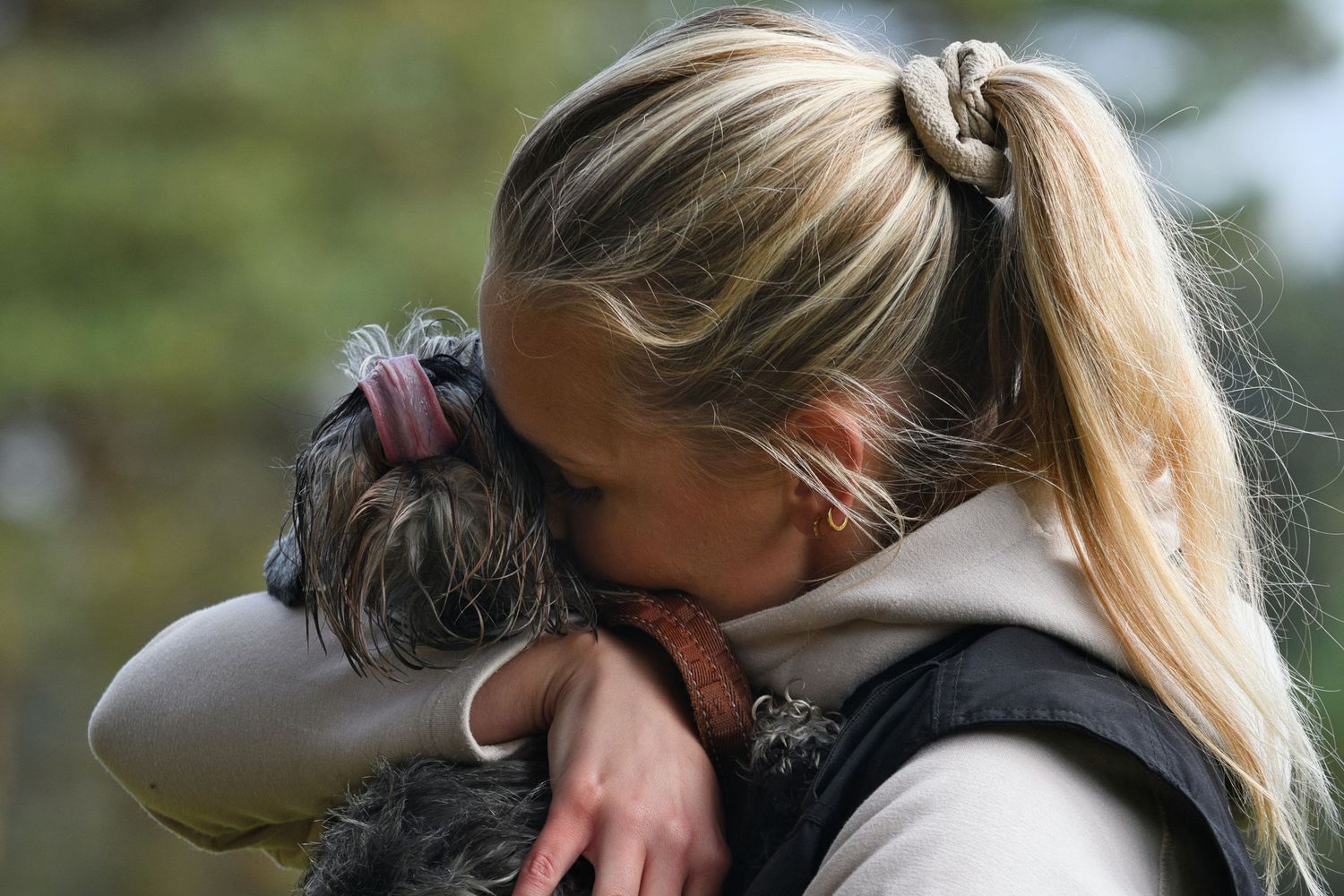 Girl and dog hugging