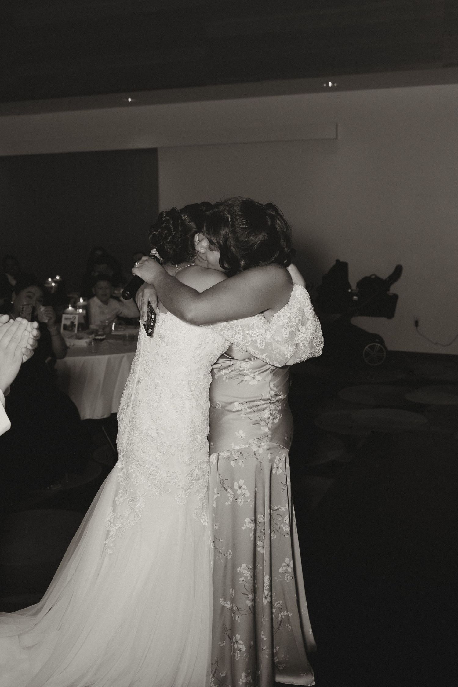 Wedding dresses displayed side by side showing delicate white lace and tulle details.