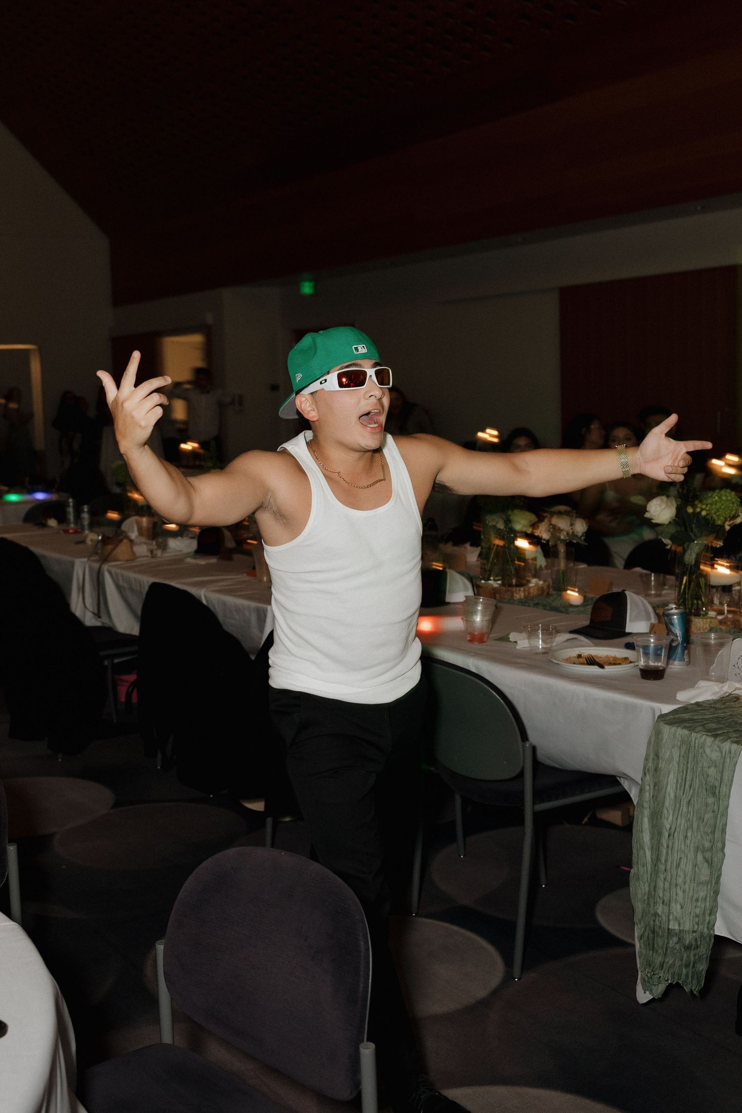 Wedding guests dancing and having fun at an indoor reception venue.