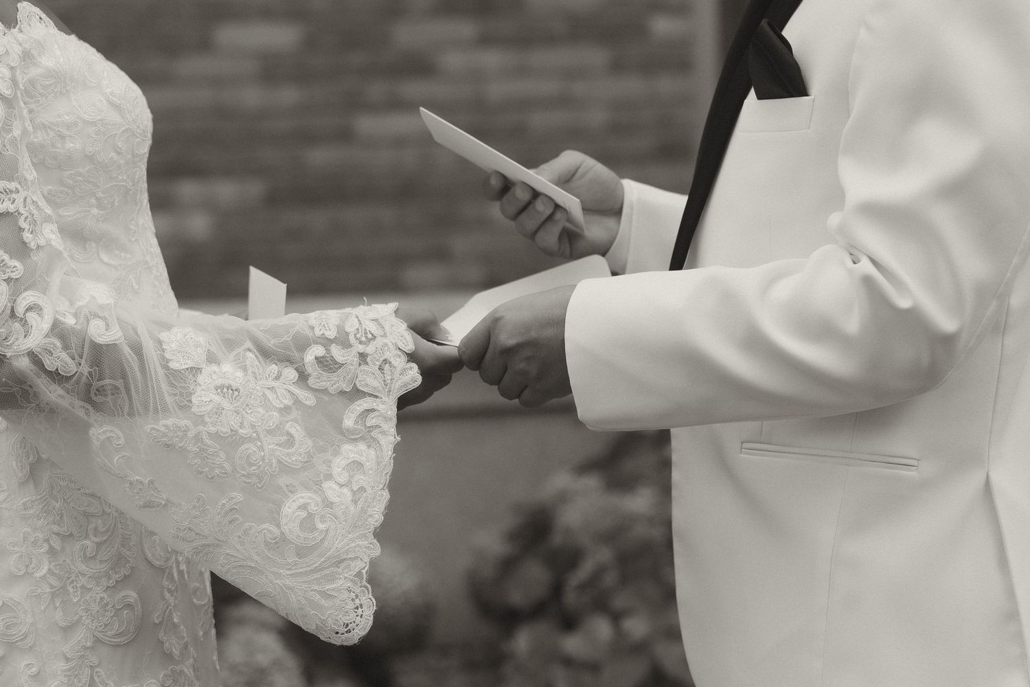 Wedding couple exchanges vows during outdoor ceremony.