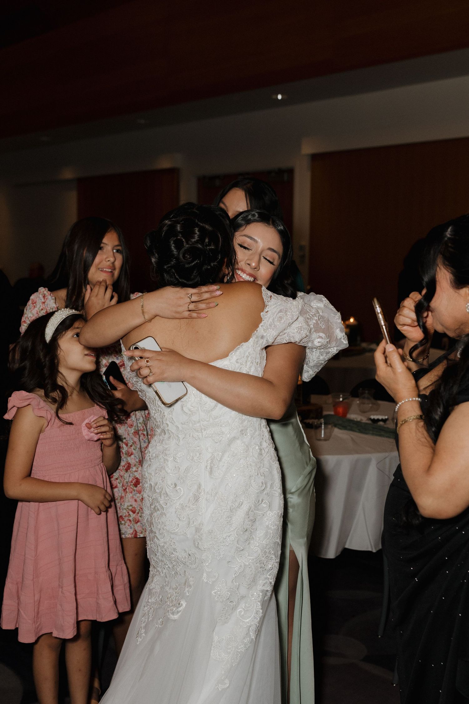 Wedding party members take shots together during reception celebrations.
