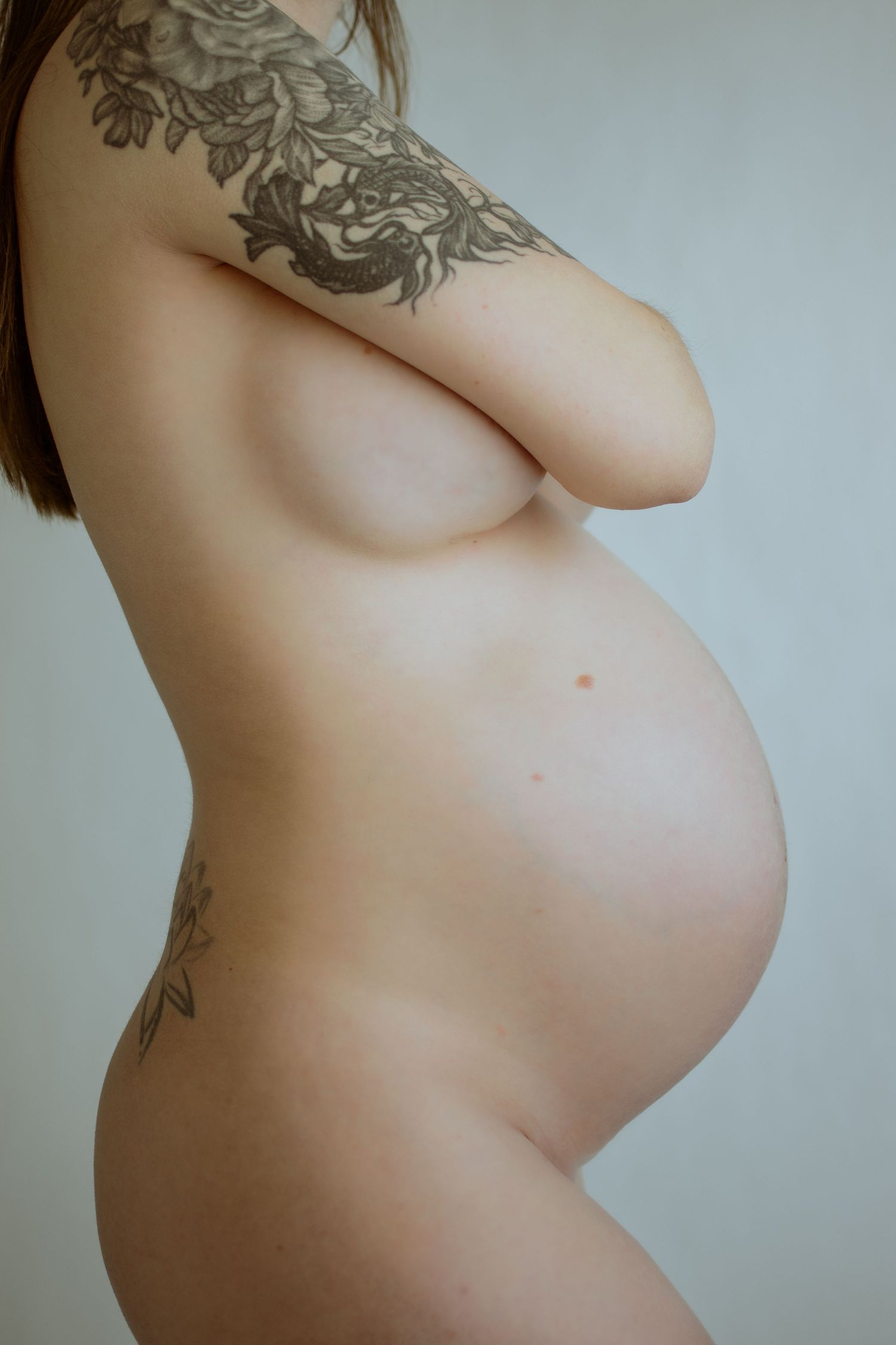 Artistic nude maternity silhouette series showing pregnancy progression.