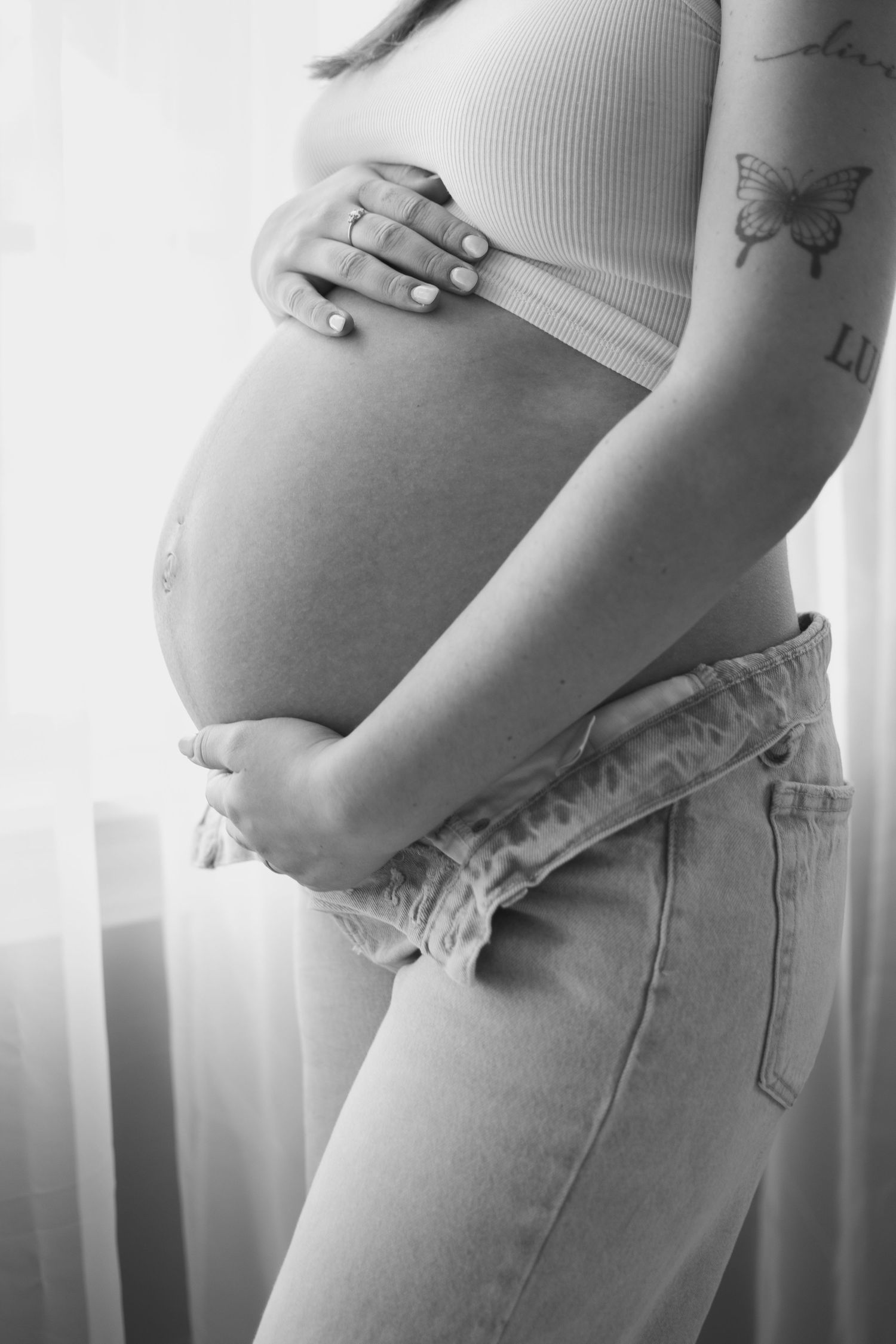 Black and white maternity progression photos showing growing baby bump.