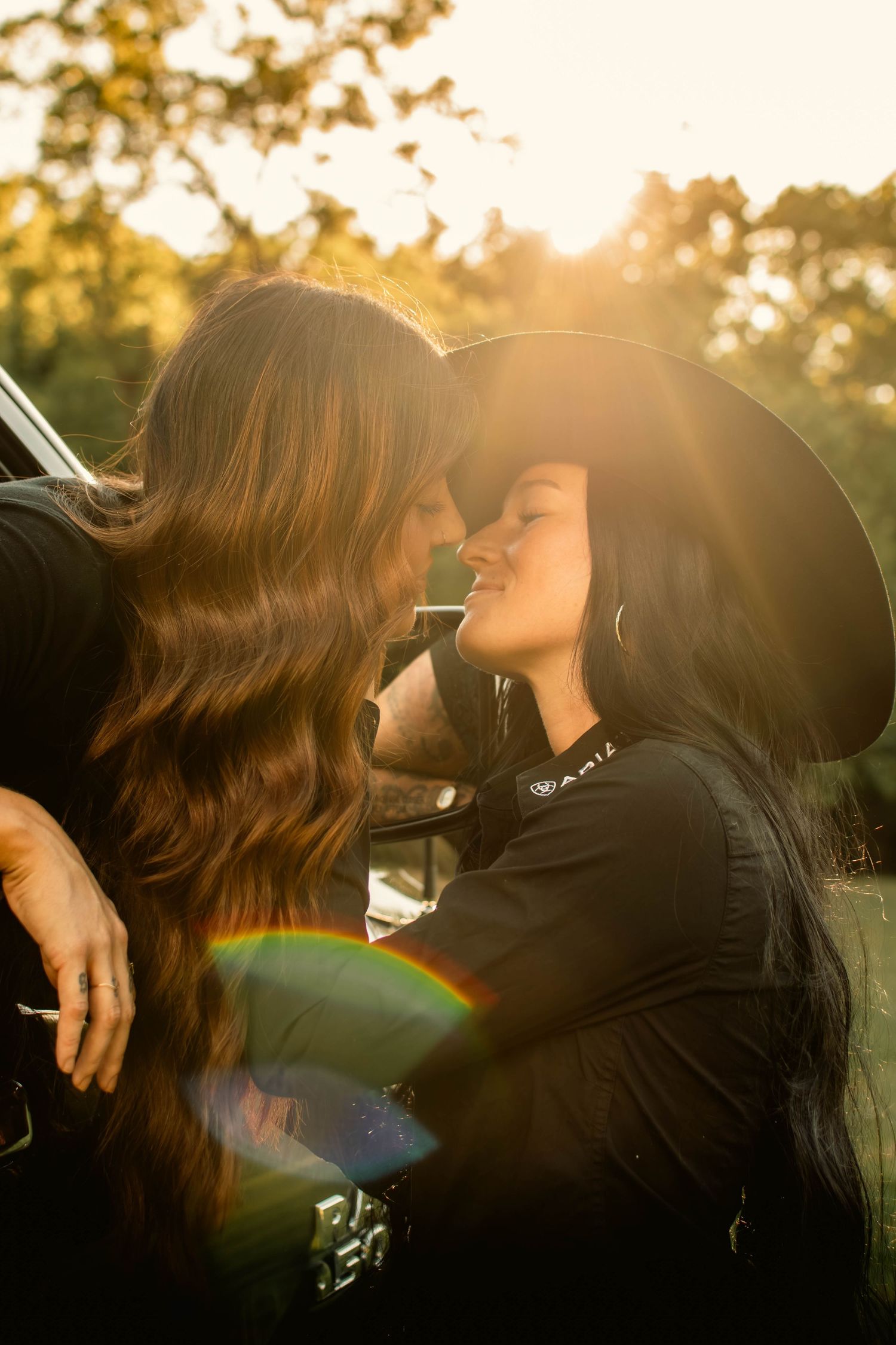 Intimate sunset moment shared in back of pickup truck.