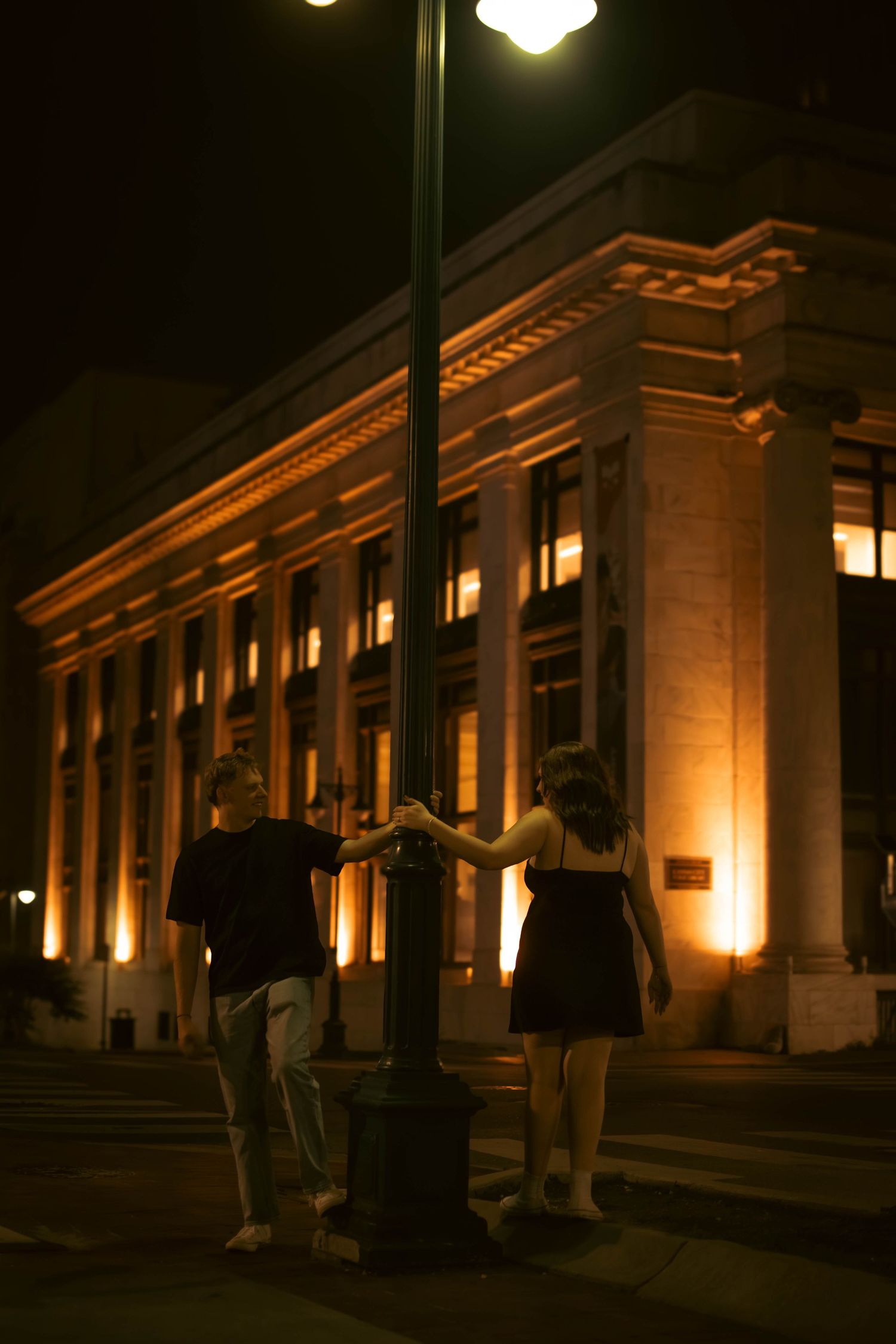Illuminated historic building facade at night with warm lighting.