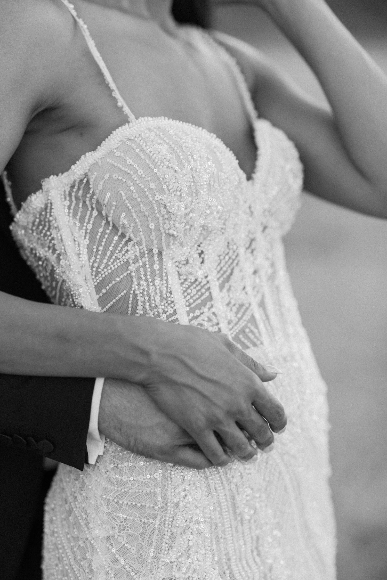 Detail shots of intricate beaded wedding dress bodice in black and white.