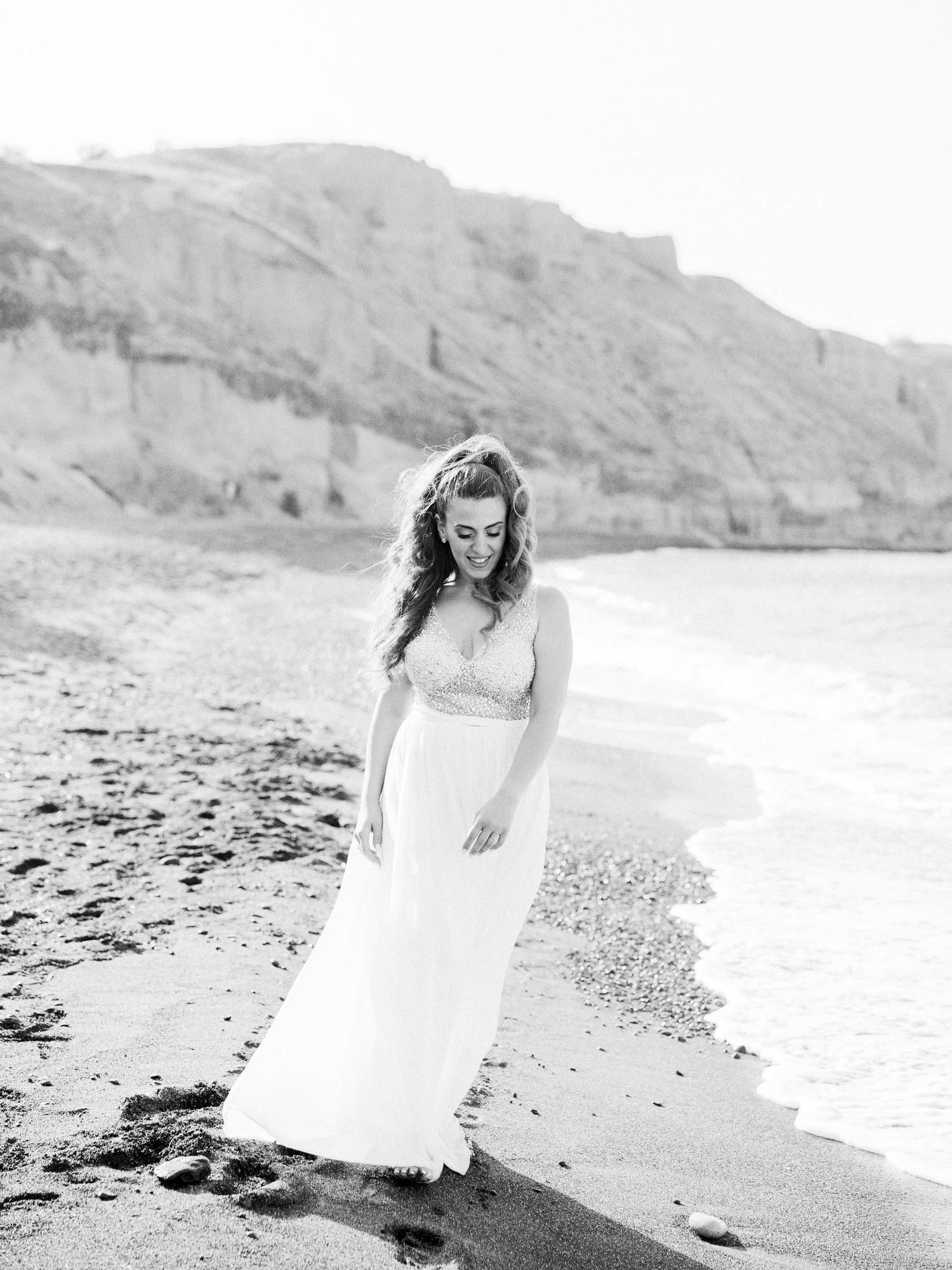 Black and white beach wedding photos with waves and rocky coastline.