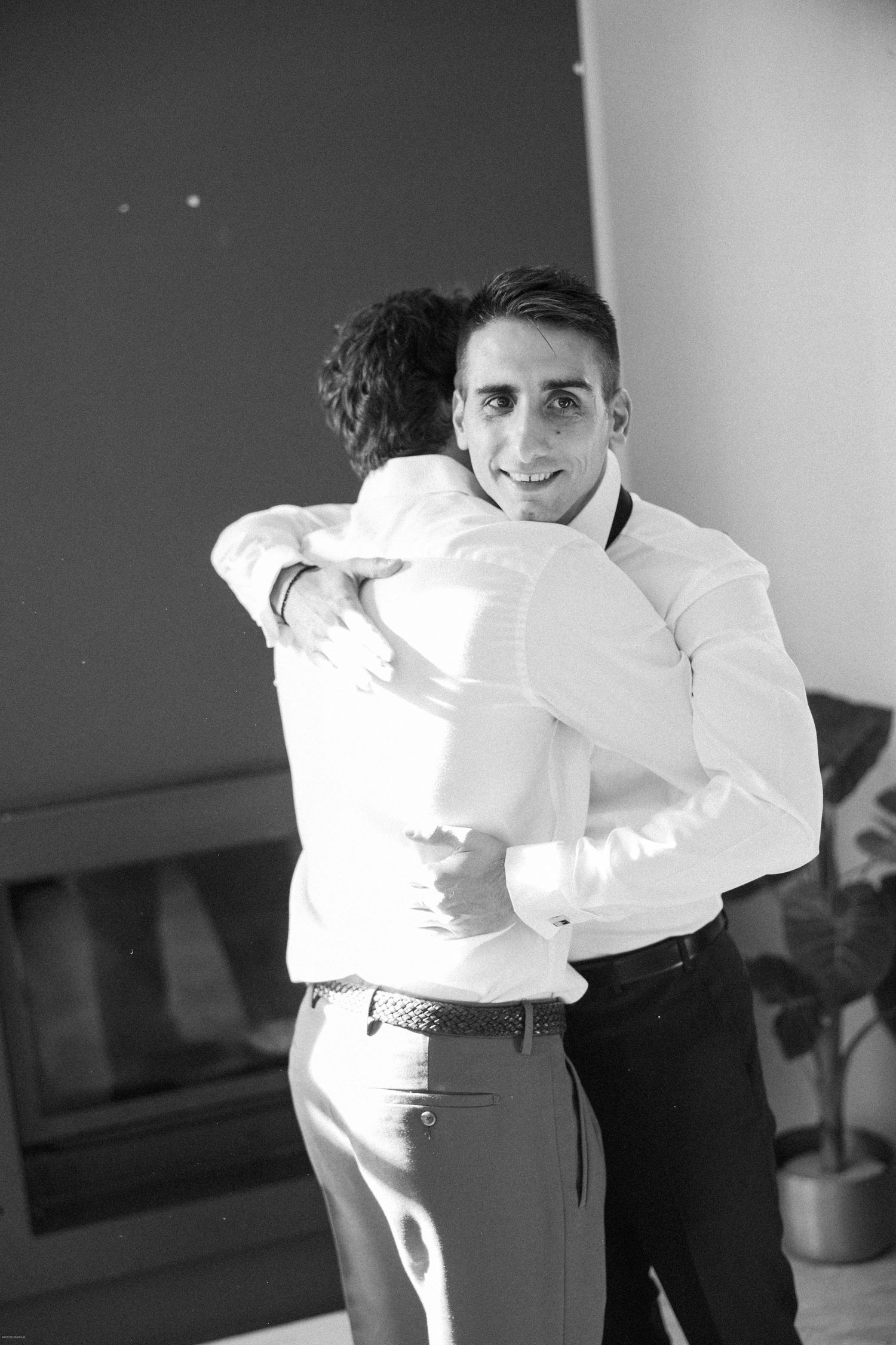 Black and white photo of people in formal attire preparing for an event.