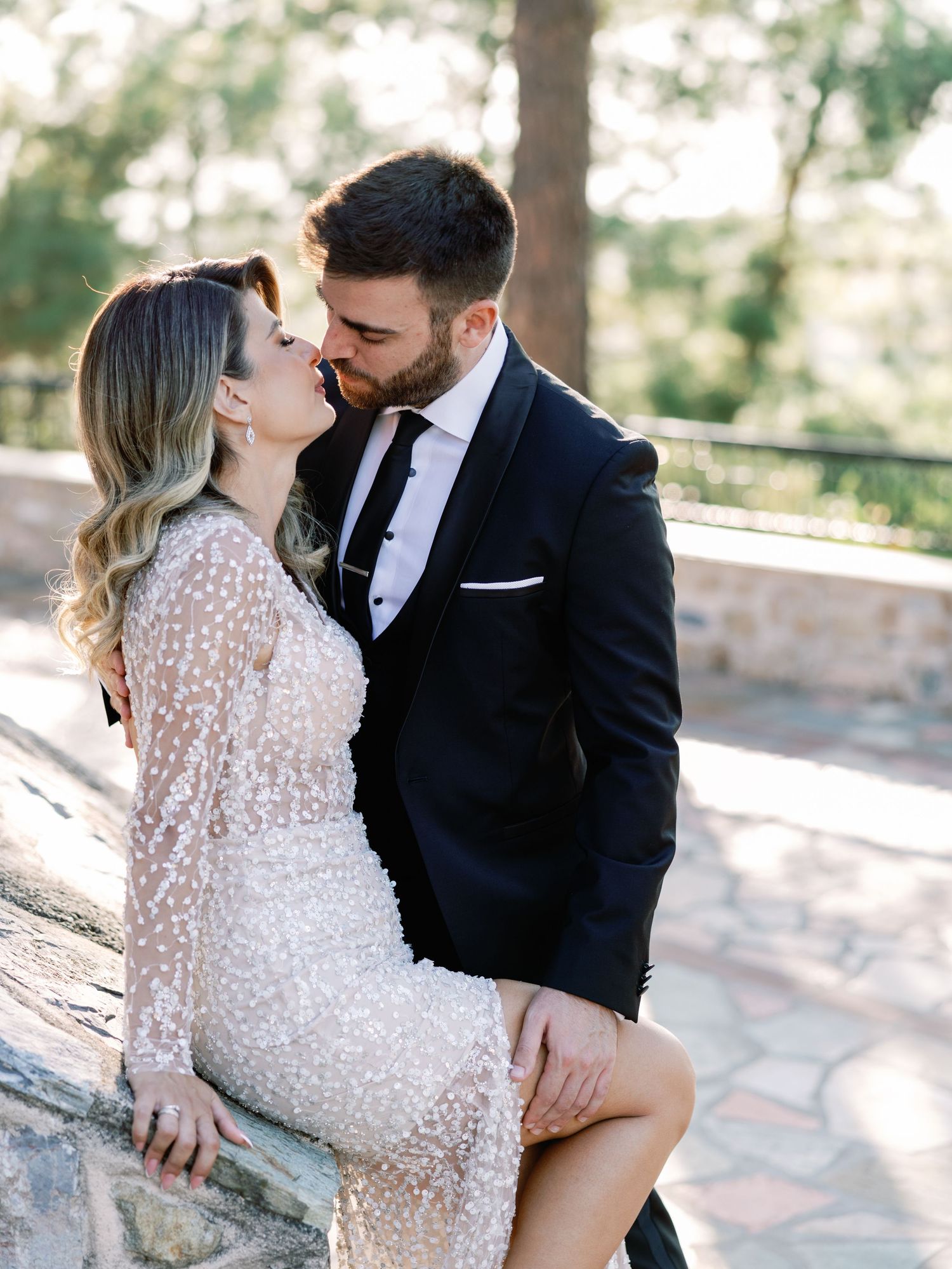 Intimate wedding portraits showing tender moments between couple in lace dress and dark suit.