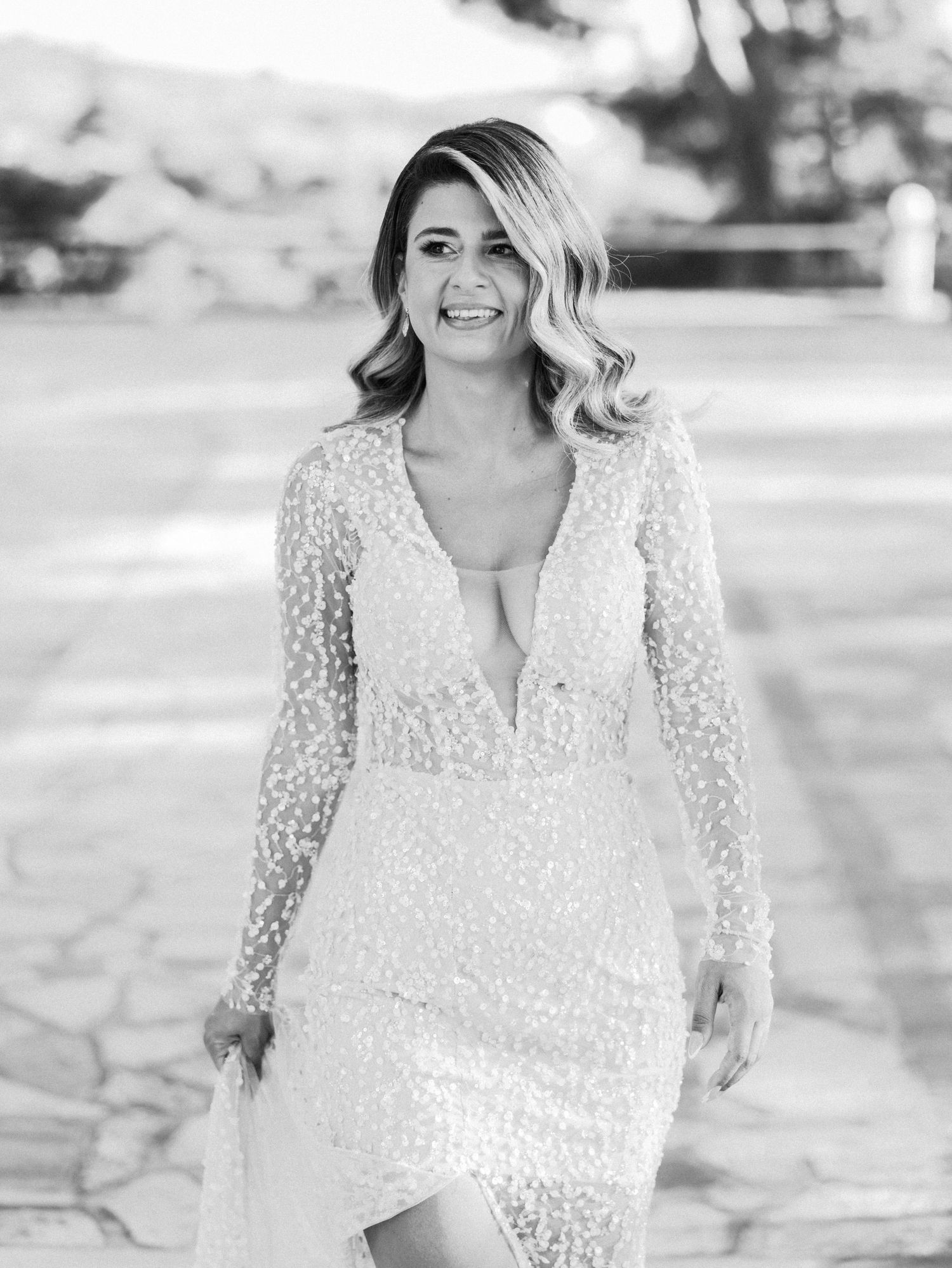 Black and white portraits showcase bride in delicate lace gown during outdoor session.