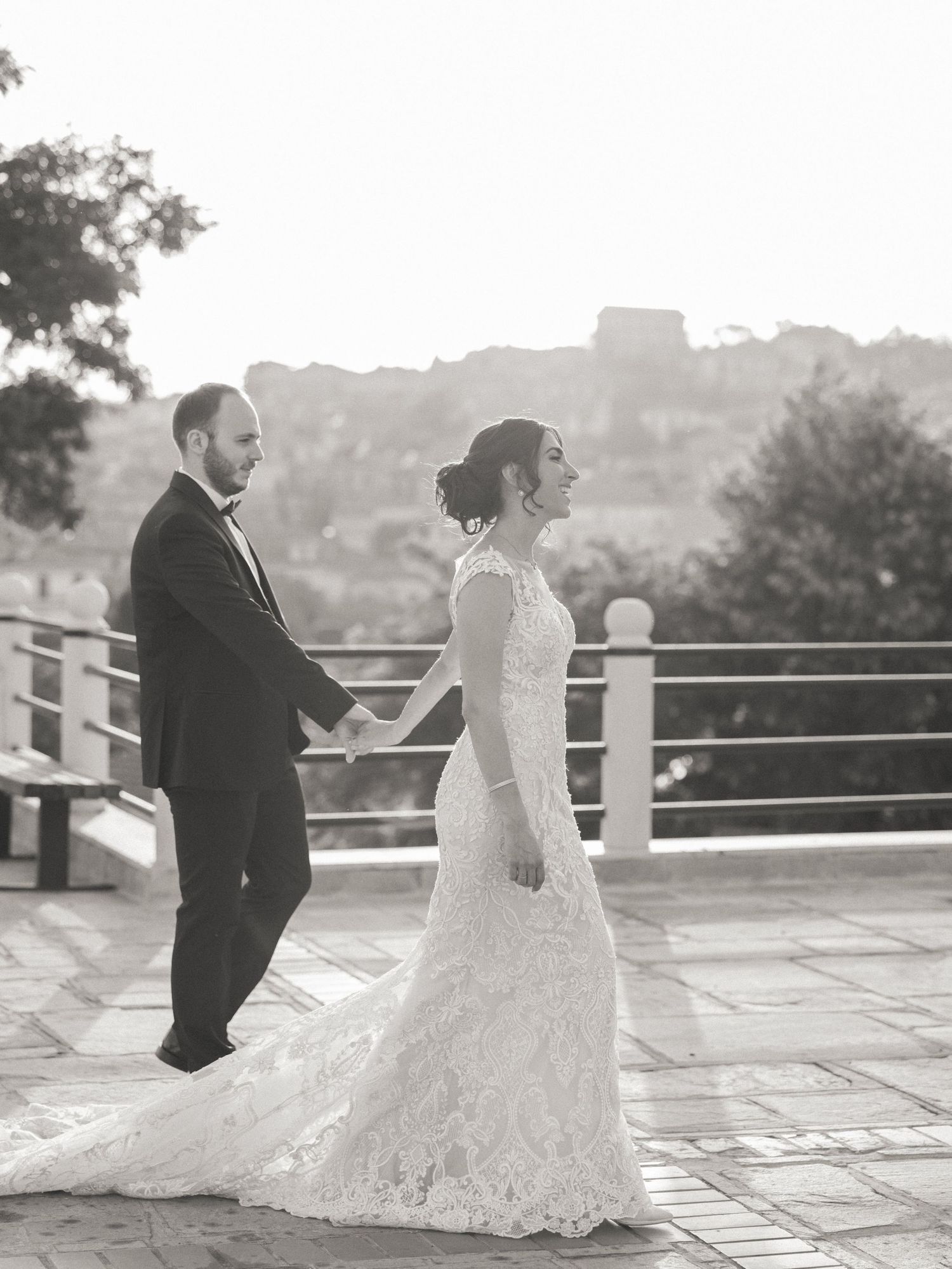 Black and white wedding portraits taken on an elegant stone terrace.